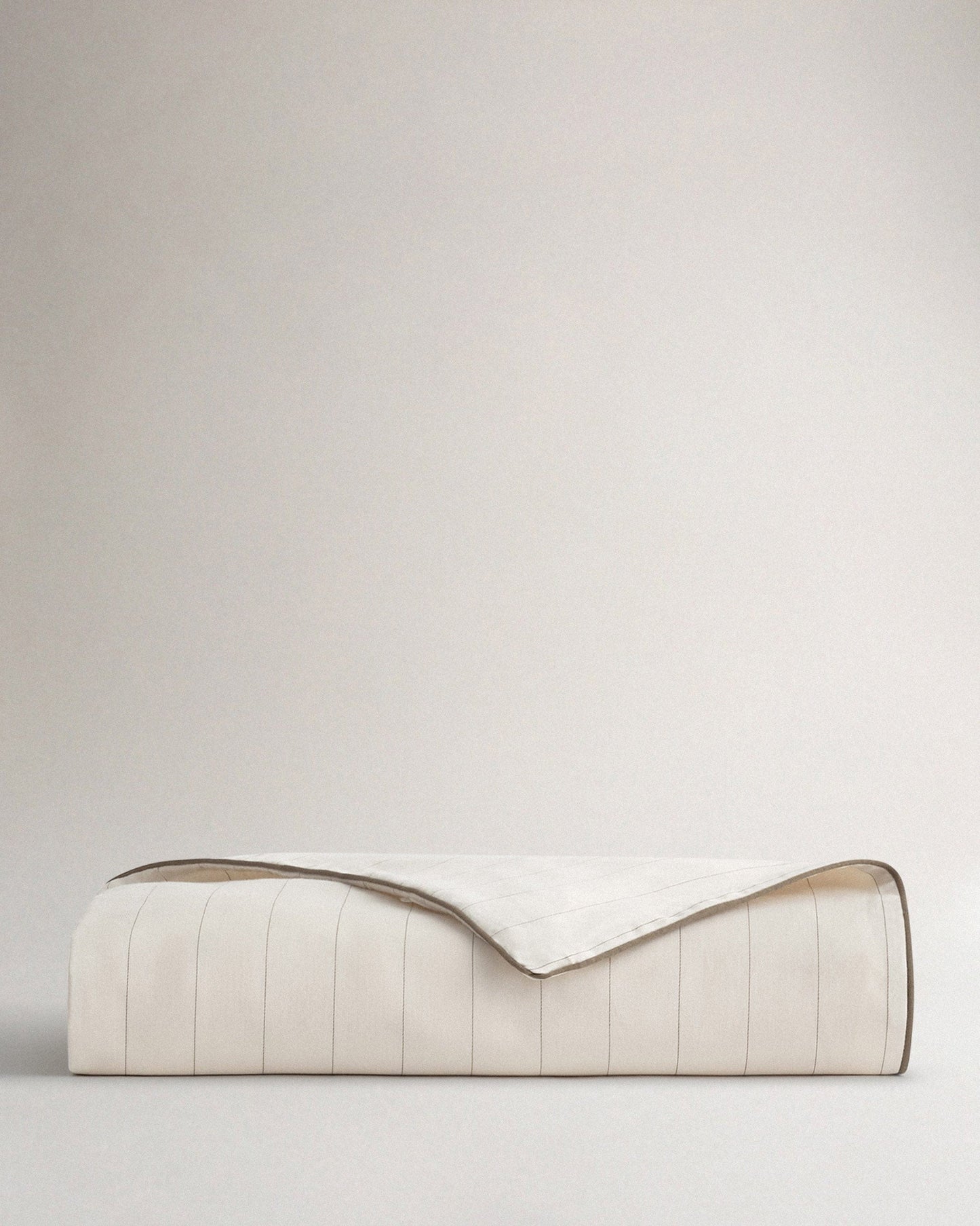 Image 1 of 2 showing Rise & Fall's sateen cotton duvet cover in buttermilk stripe.