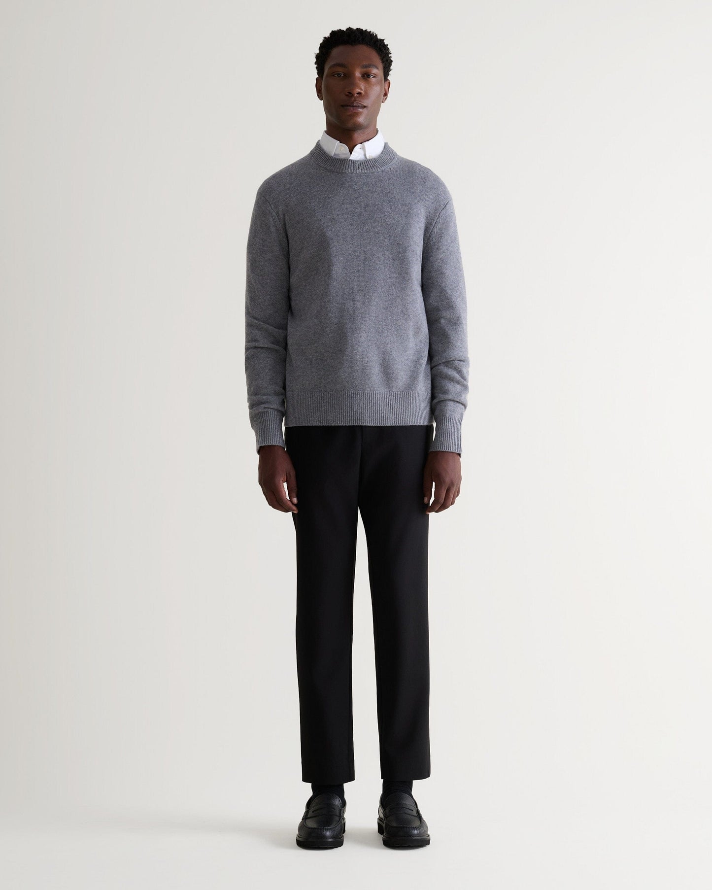 Image 1 of 5 showing man wearing Rise & Fall's finest cashmere mid-weight crew neck jumper in grey with white shirt and black jeans.