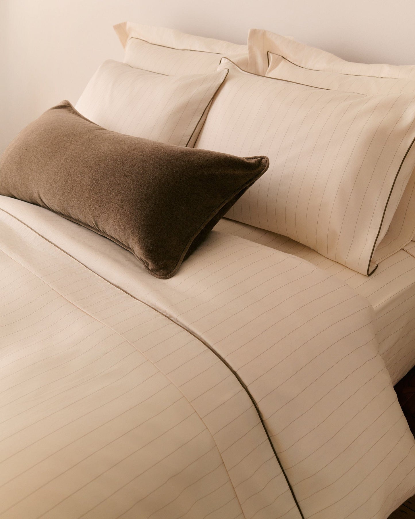 image 2 of 2 showing Rise & Fall's buttermilk stripe Soft & Smooth duvet set with olive velvet cushion, fabric: sateen cotton