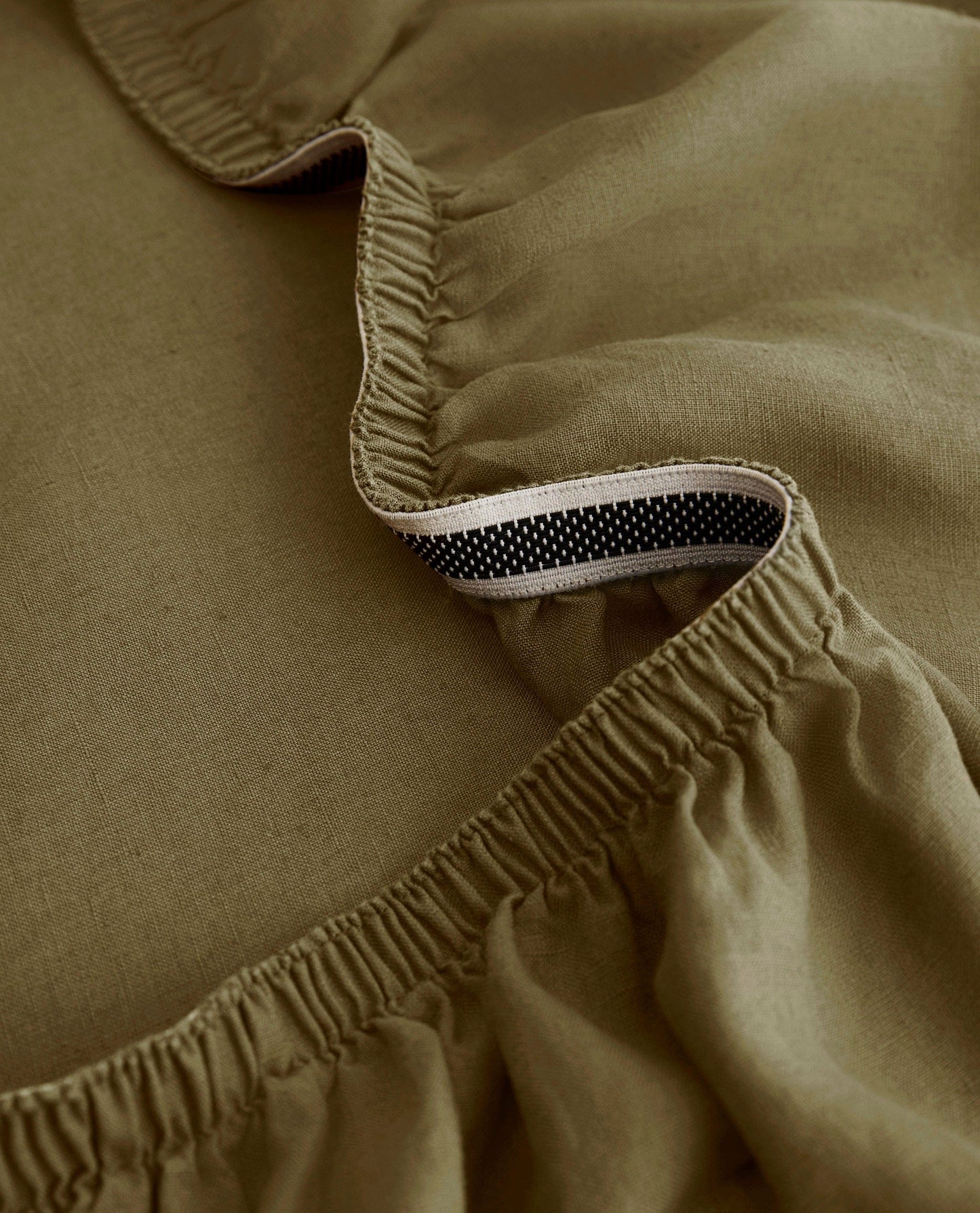 Image 2 of 4 showing Rise & Fall's Relaxed & Refined European flax™ linen fitted sheet in olive.