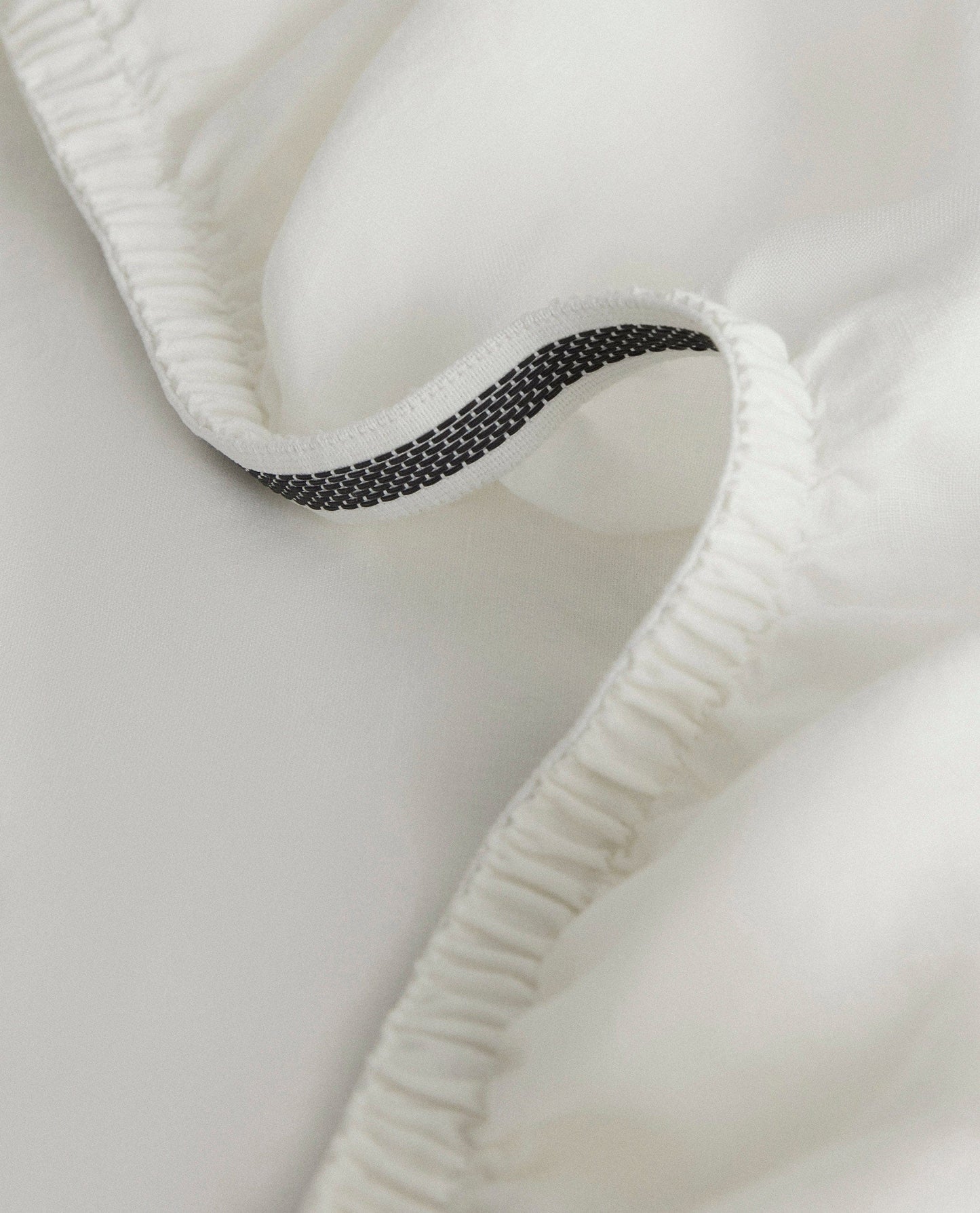 Image 2 of 5 showing Rise & Fall's Relaxed & Refined European flax™ linen fitted sheet in white.
