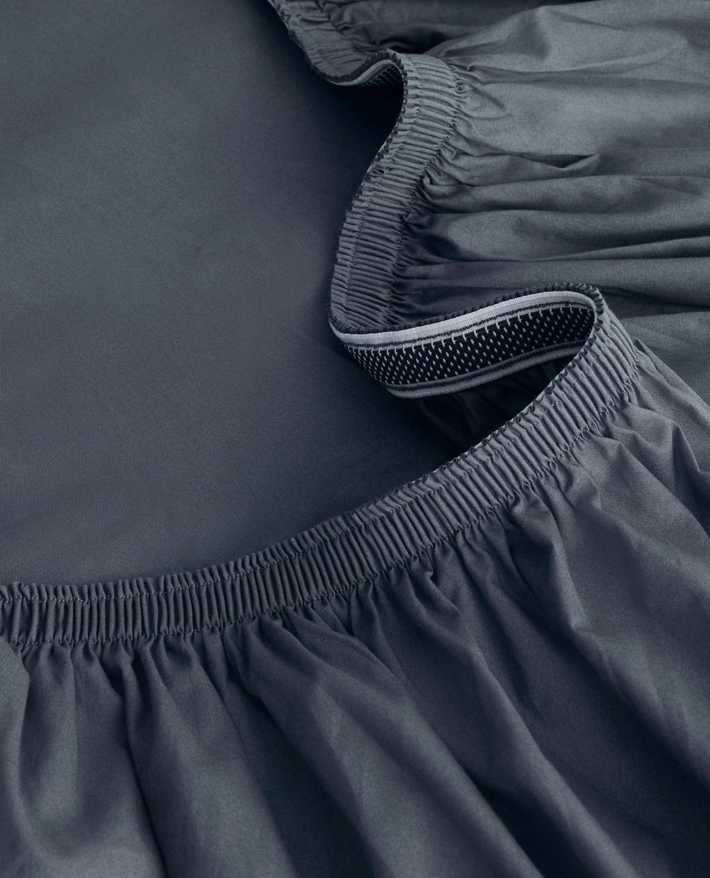 Image 2 of 6 showing close up of Rise & Fall's Crisp & Cool organic cotton fitted sheet in indigo.