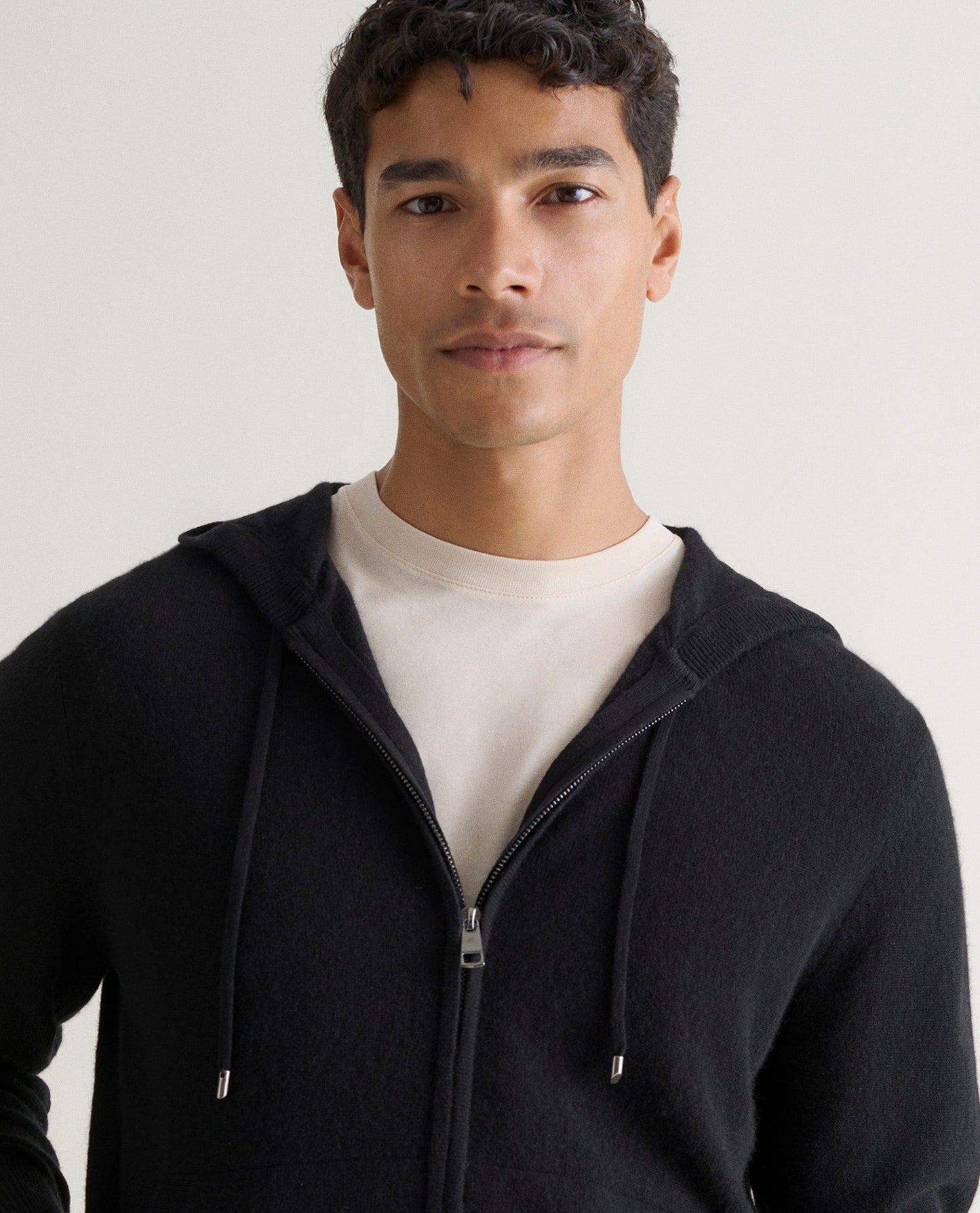 Image 3 of 4 showing man wearing Rise & Fall's fine cashmere zip hoodie, black.