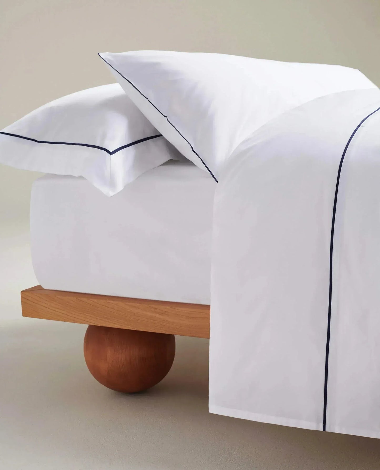 Image 3 of 4 showing Rise & Fall's Crisp & Cool organic cotton percale flat sheet in white navy piping.
