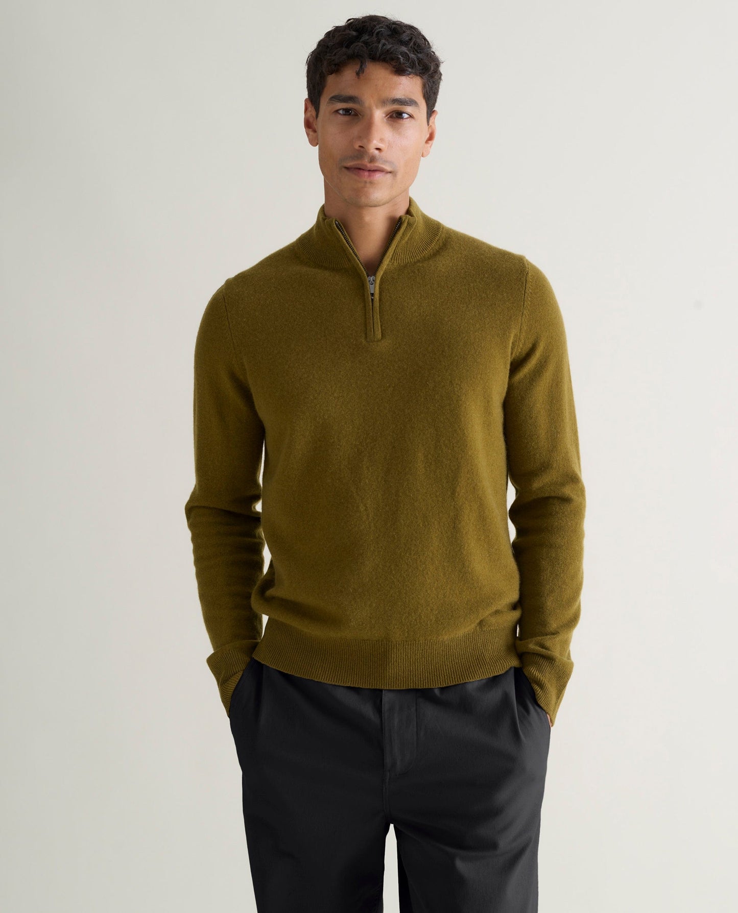Image 3 of 5 showing man wearing Rise & Fall's fine cashmere 1/4 zip jumper, olive.