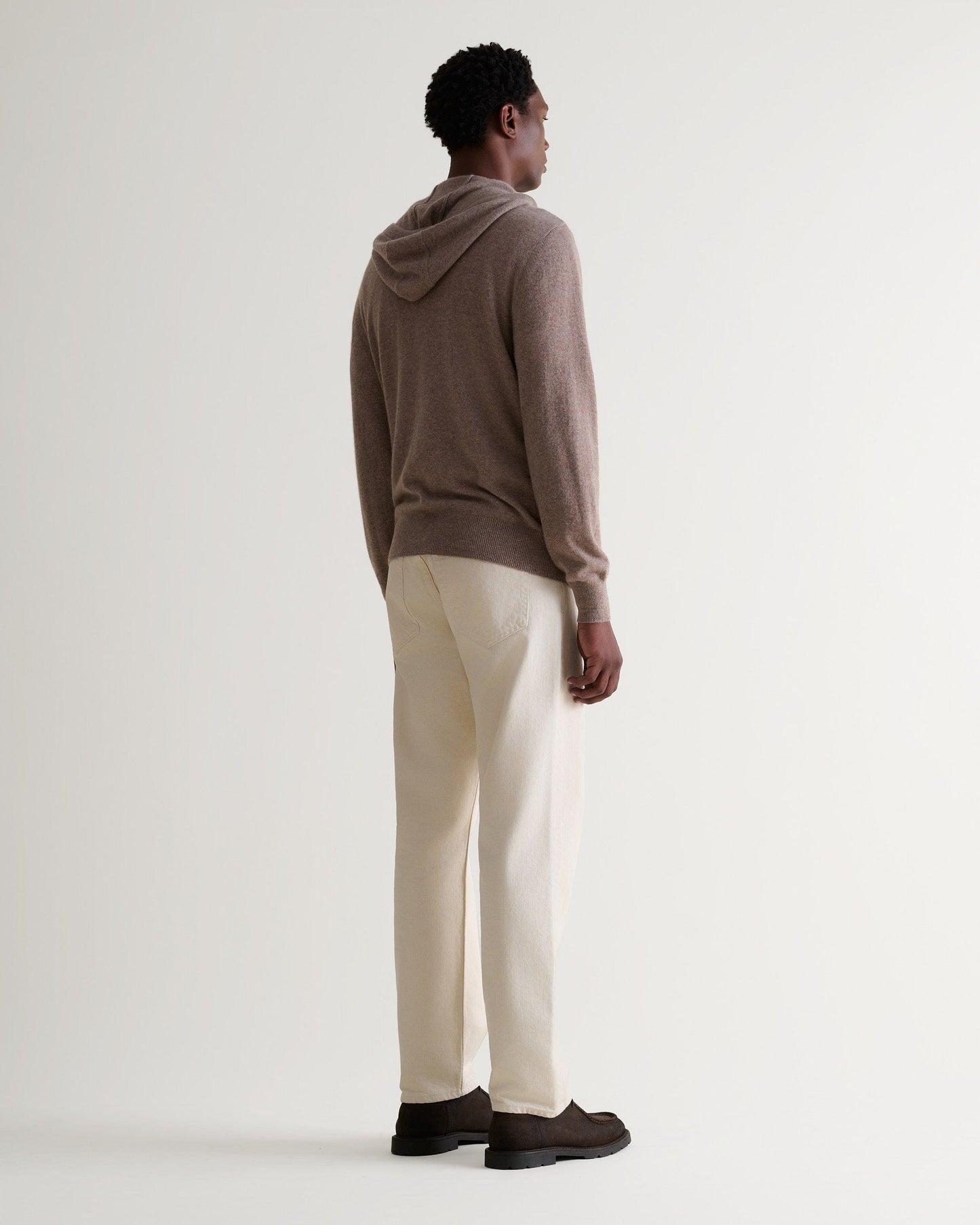 Image 3 of 5 showing man wearing Rise & Fall's fine cashmere zip hoodie, toast, back view.
