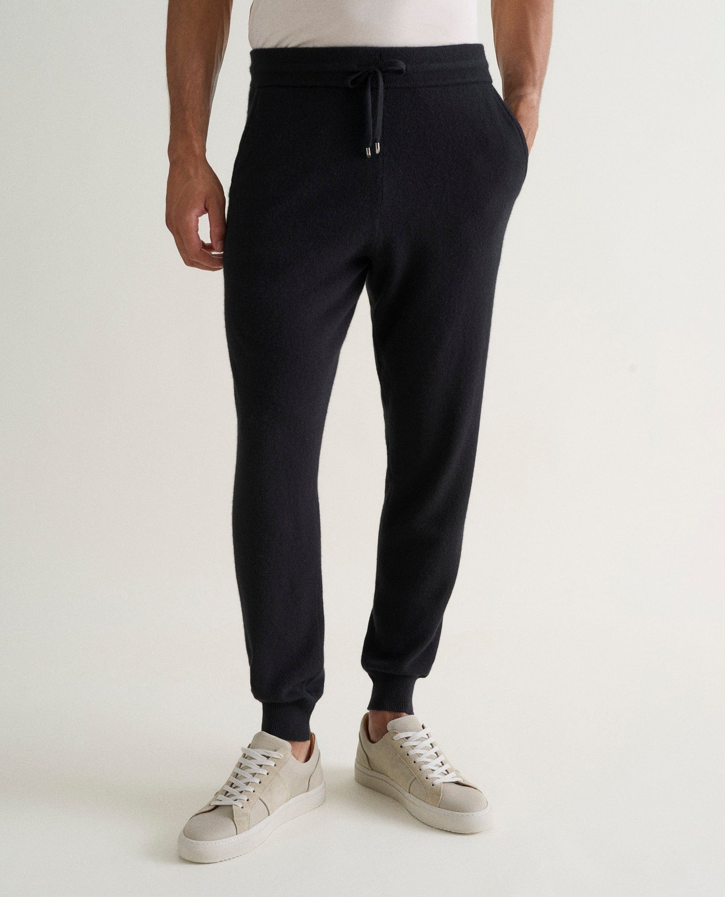 Image 3 of 5 showing man wearing Rise & Fall's fine cashmere joggers, black.
