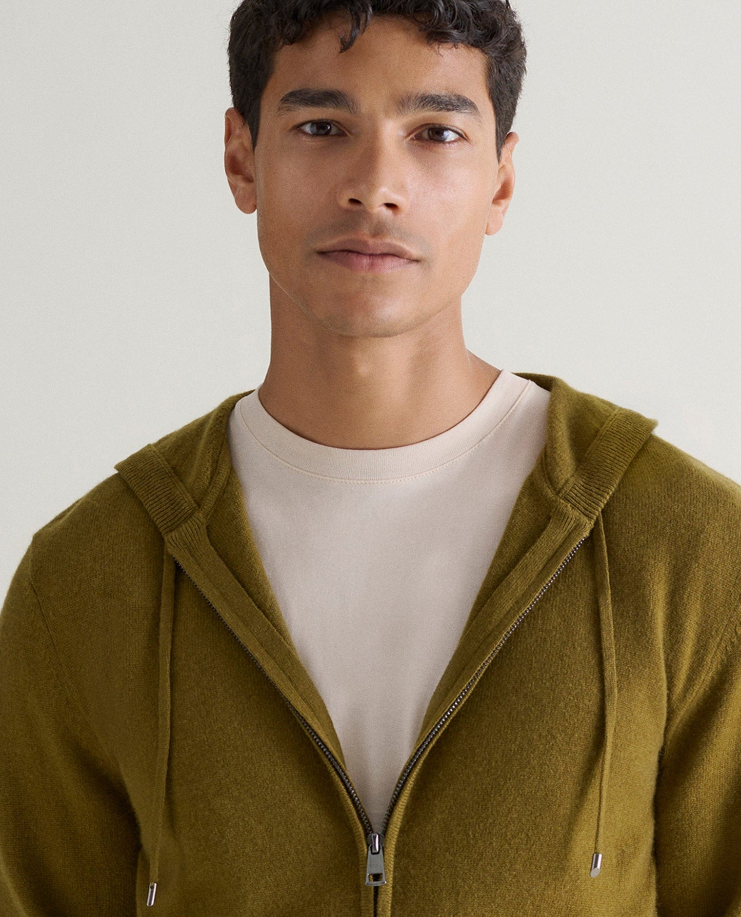 Image 4 of 5 showing man wearing Rise & Fall's Finest Cashmere Full Zip Hoodie in olive green.