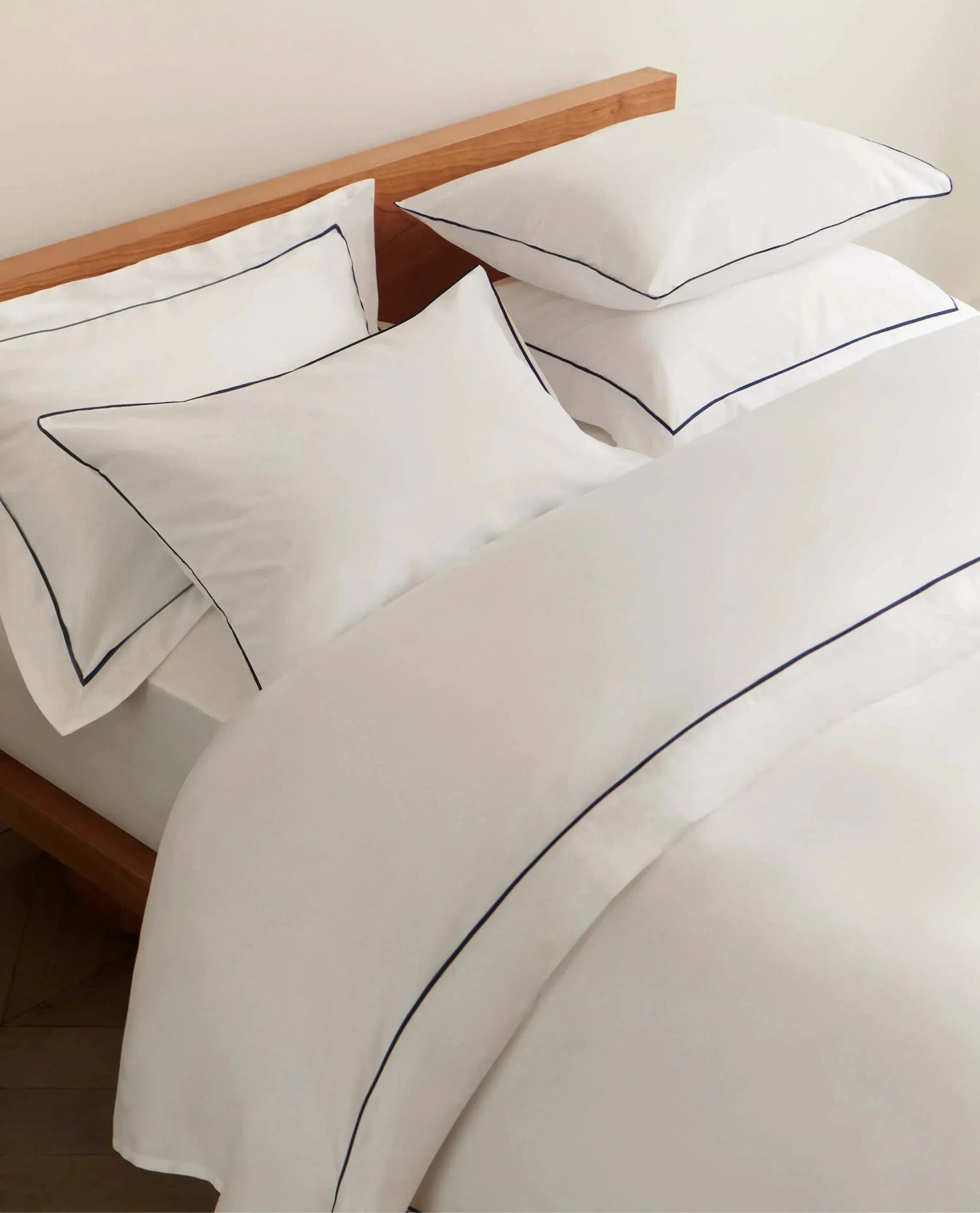 Image 4 of 5 showing Rise & Fall's sateen cotton duvet cover, colour: white navy piping.