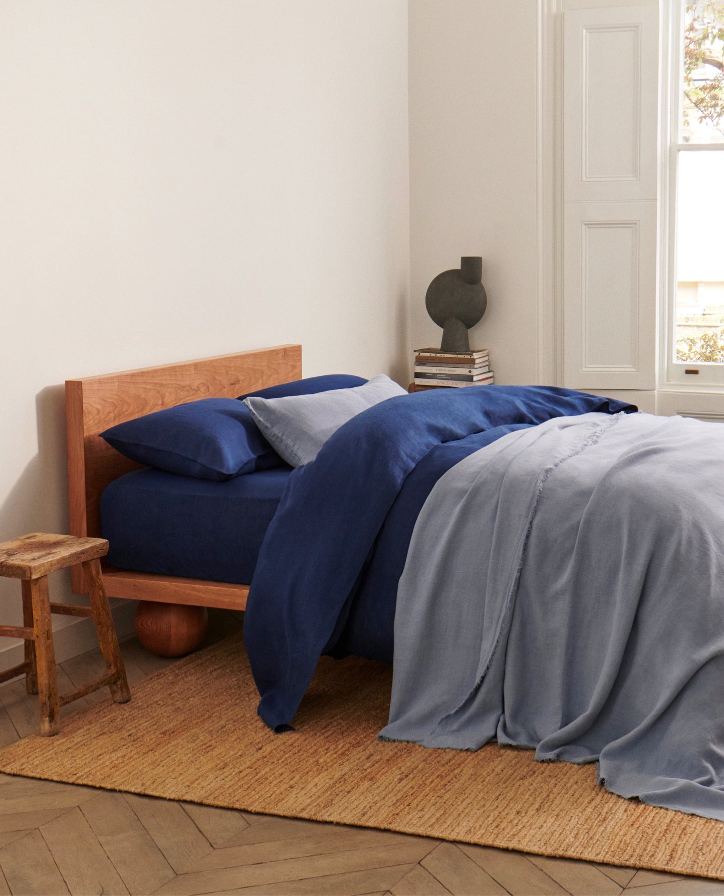 image 4 of 6 showing bed with Rise & Fall's Relaxed & Refined flax linen duvet set in indigo with complementary throw and cushion