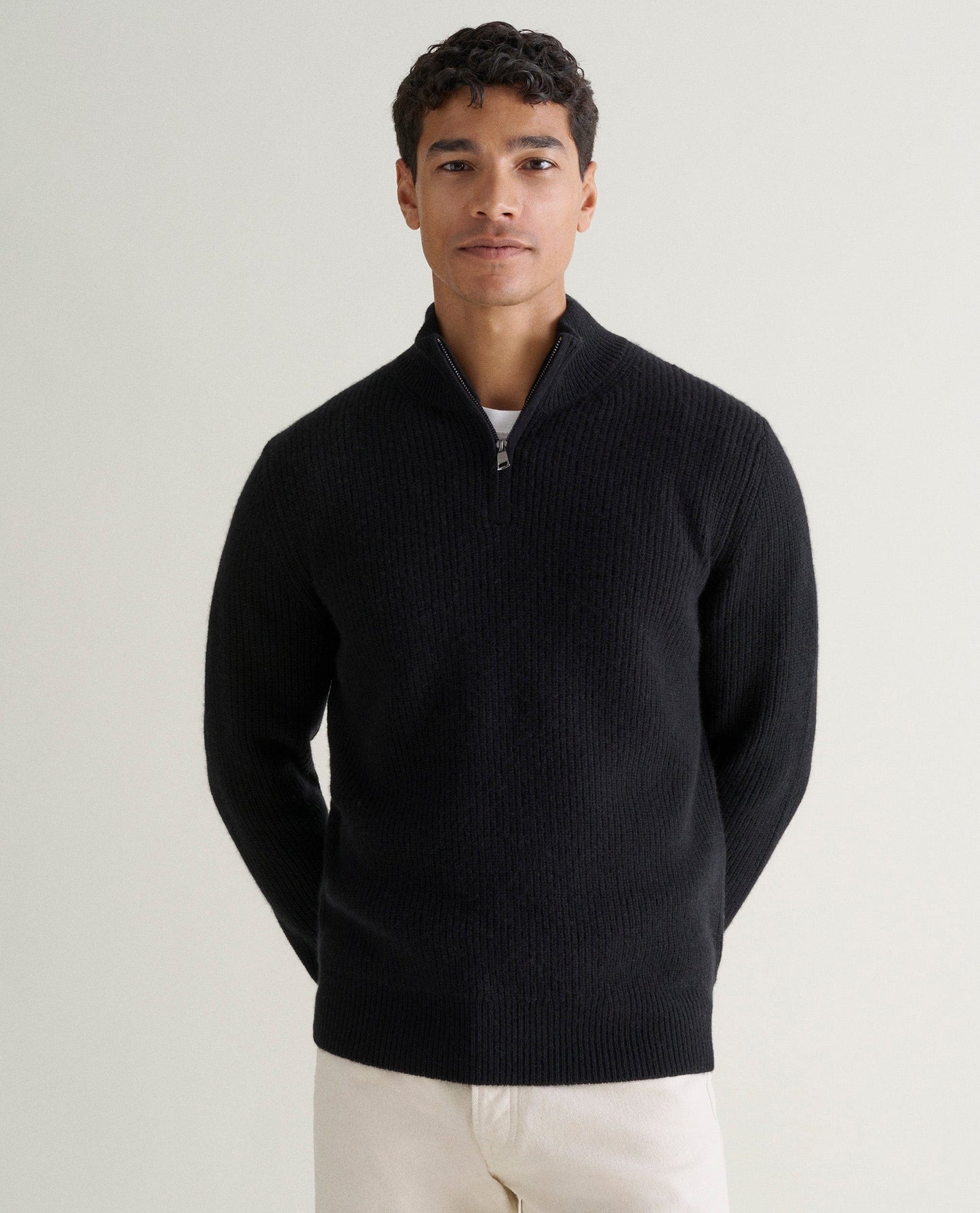 Image 4 of 6 showing man wearing Rise & Fall's Cashmere Merino Fishermans Rib 1/4 Zip Jumper in black.