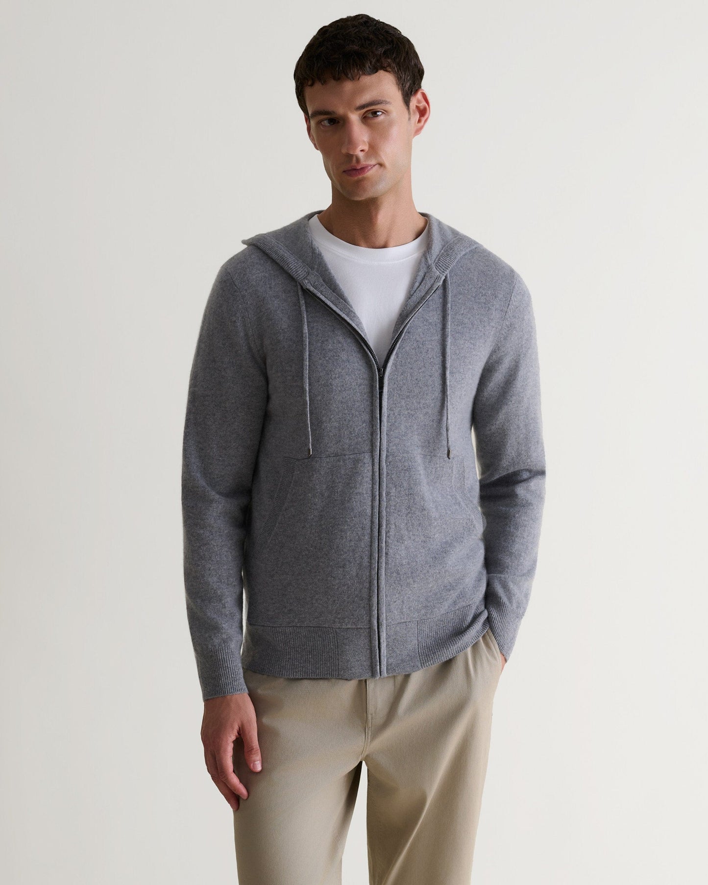 Image 4 of 6 showing man wearing Rise & Fall's fine cashmere zip hoodie, grey.