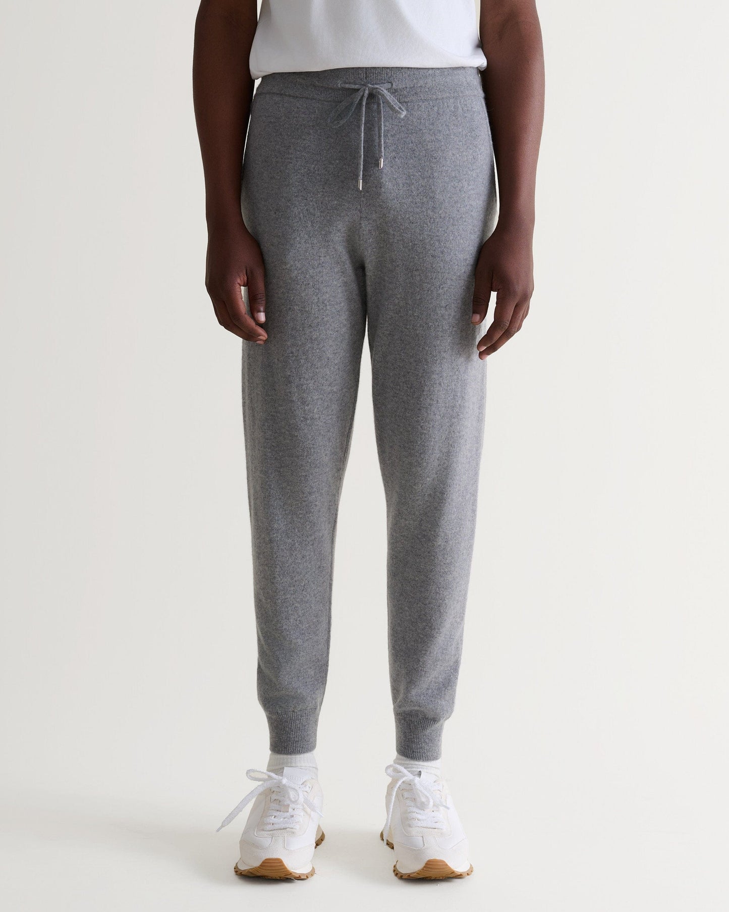 Image 4 of 6 showing man wearing Rise & Fall's fine cashmere joggers, grey.