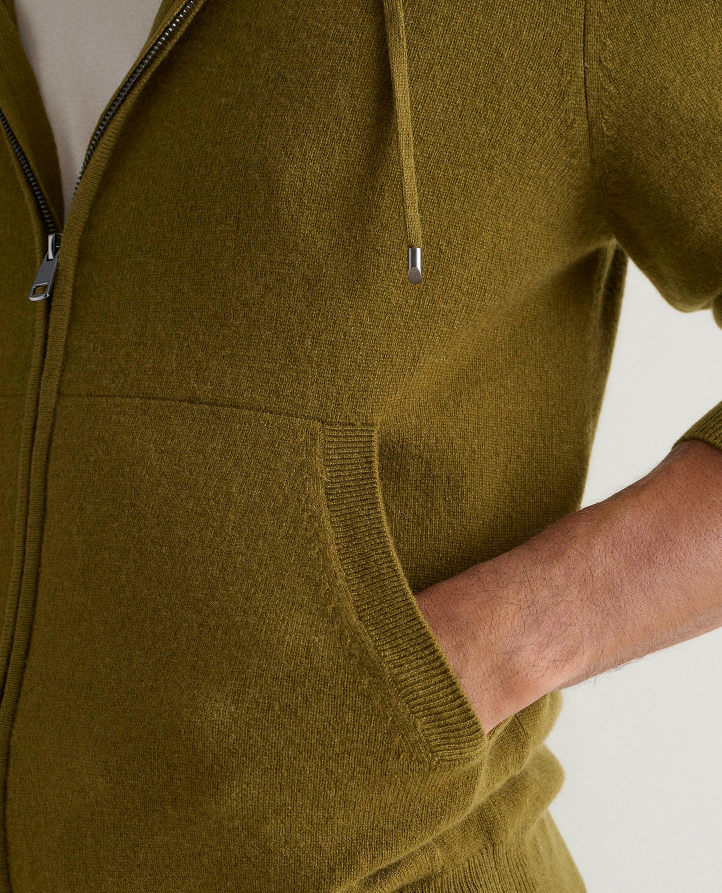Image 5 of 5 showing close up of man wearing Rise & Fall's Finest Cashmere Full Zip Hoodie in olive green.