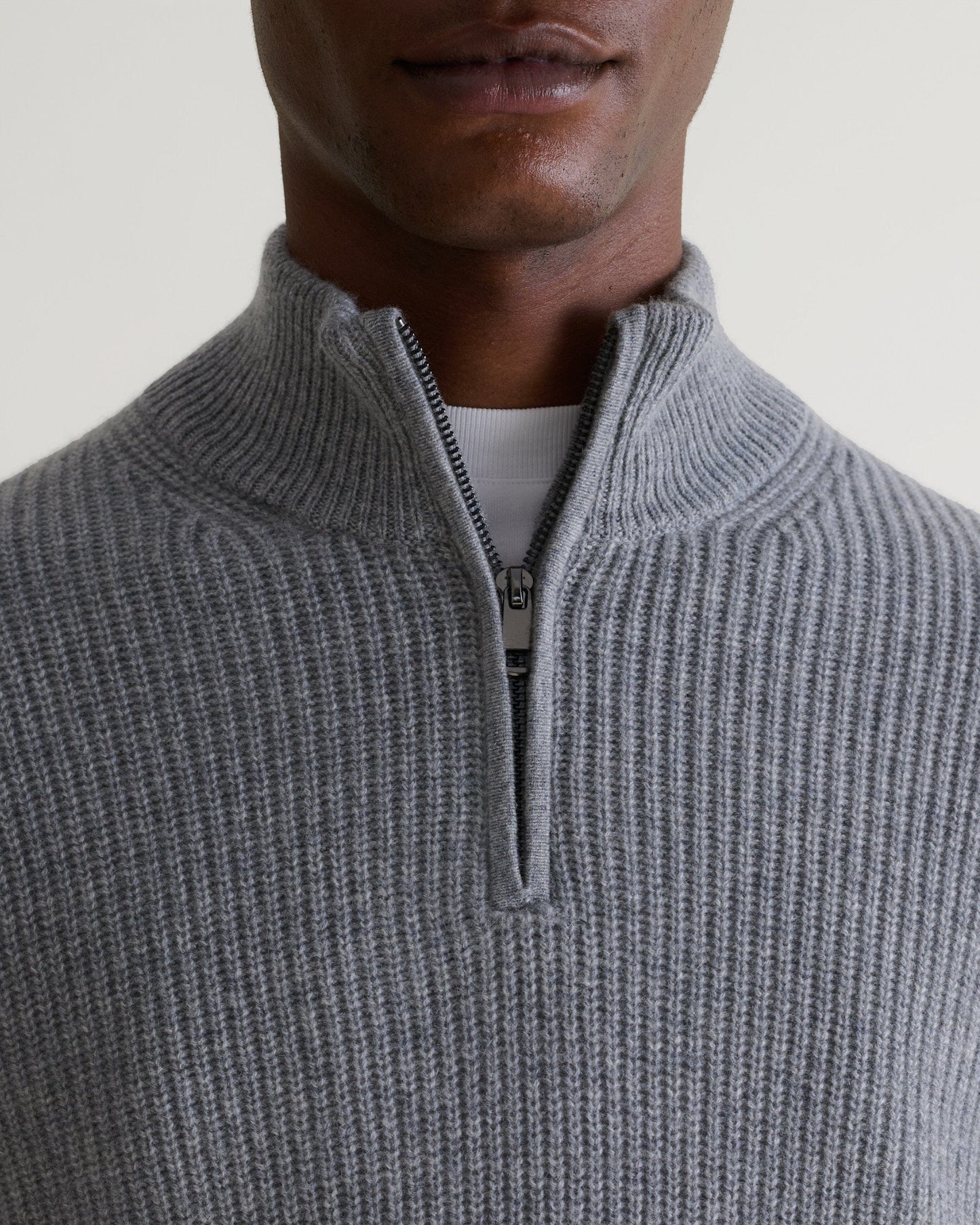 Image 5 of 6 showing close up of man wearing Rise & Fall's Cashmere Merino Fishermans Rib 1/4 Zip Jumper in grey.