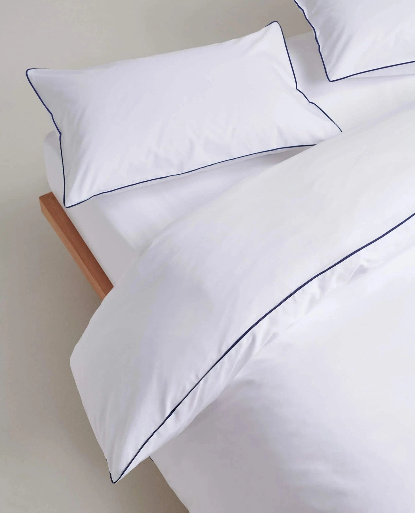 image 5 of 6 showing bed with Rise & Fall's Crisp & Cool duvet set, colour: white navy piping, fabric: percale cotton