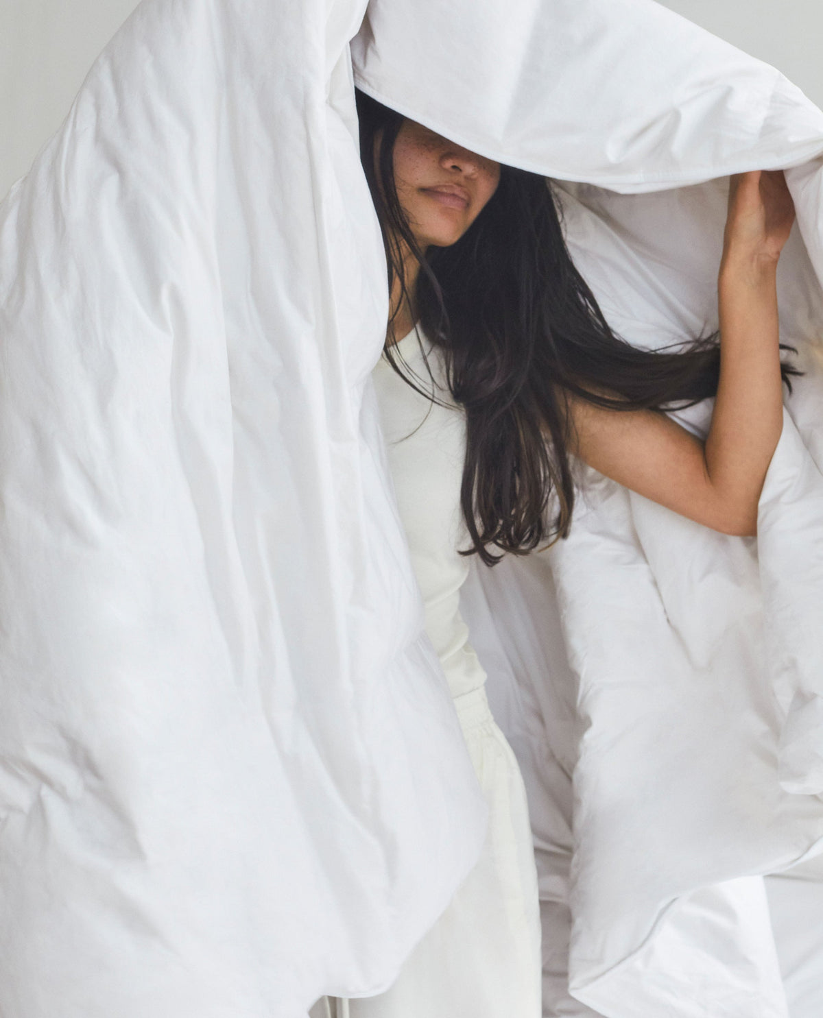 Woman Holding A Duvet.
