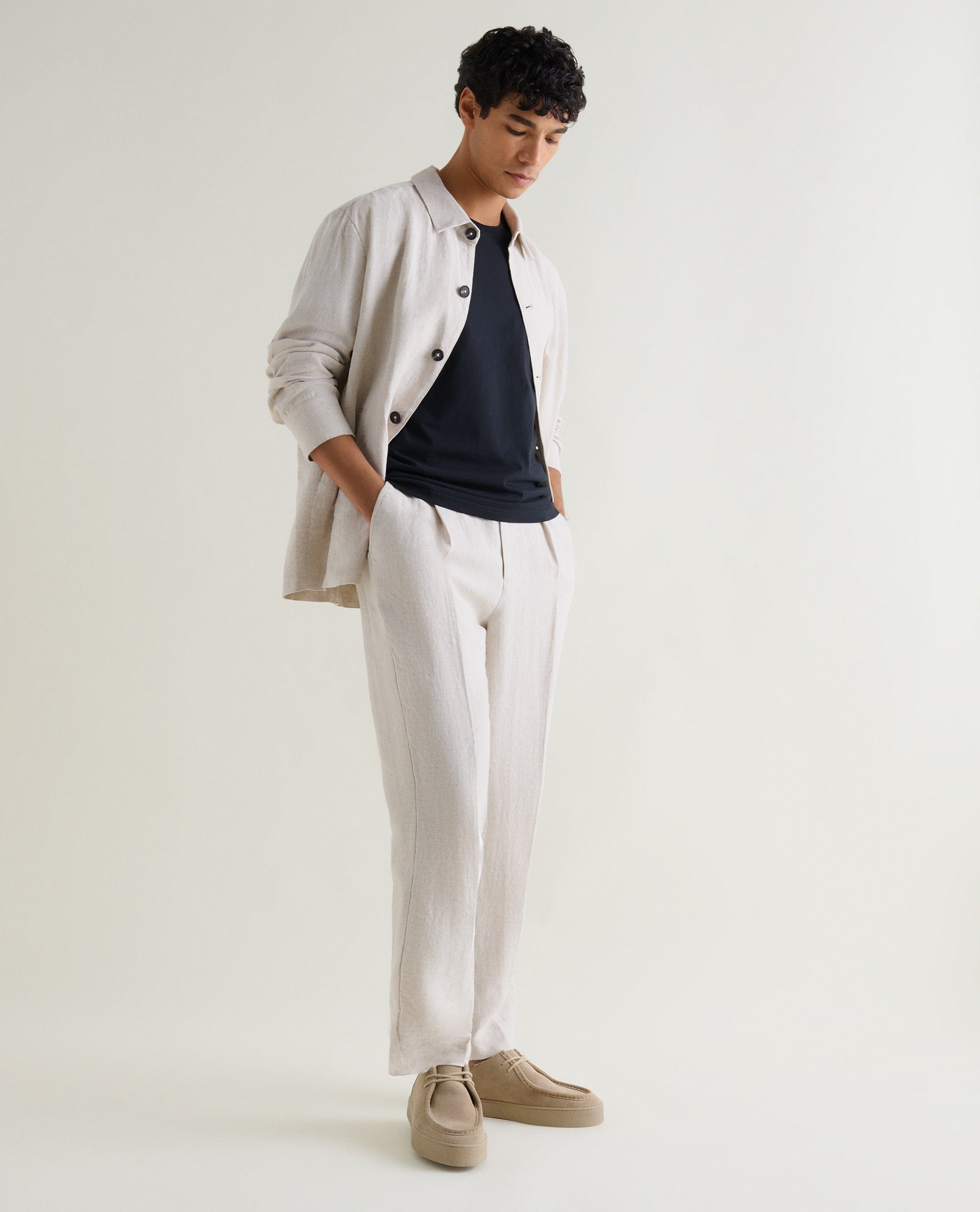 Man wear Rise & Fall's Flax Linen Suit in parchment with a black cotton T-shirt