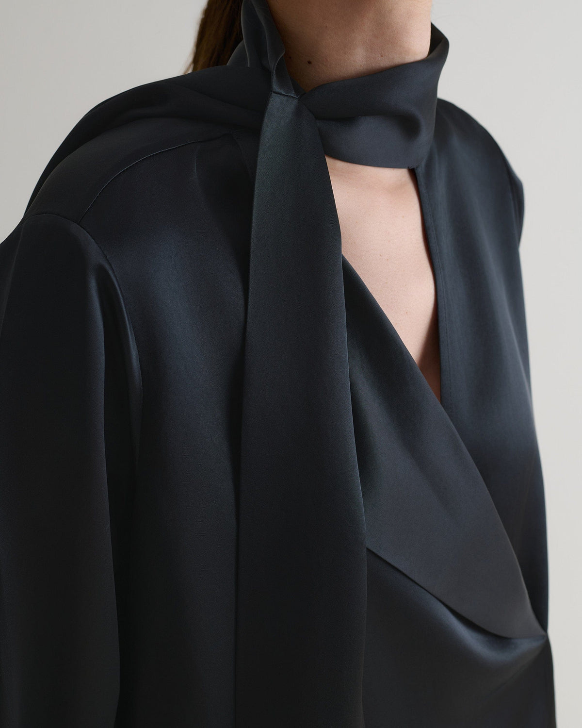 Black Naia™ blouse with neck tie. 