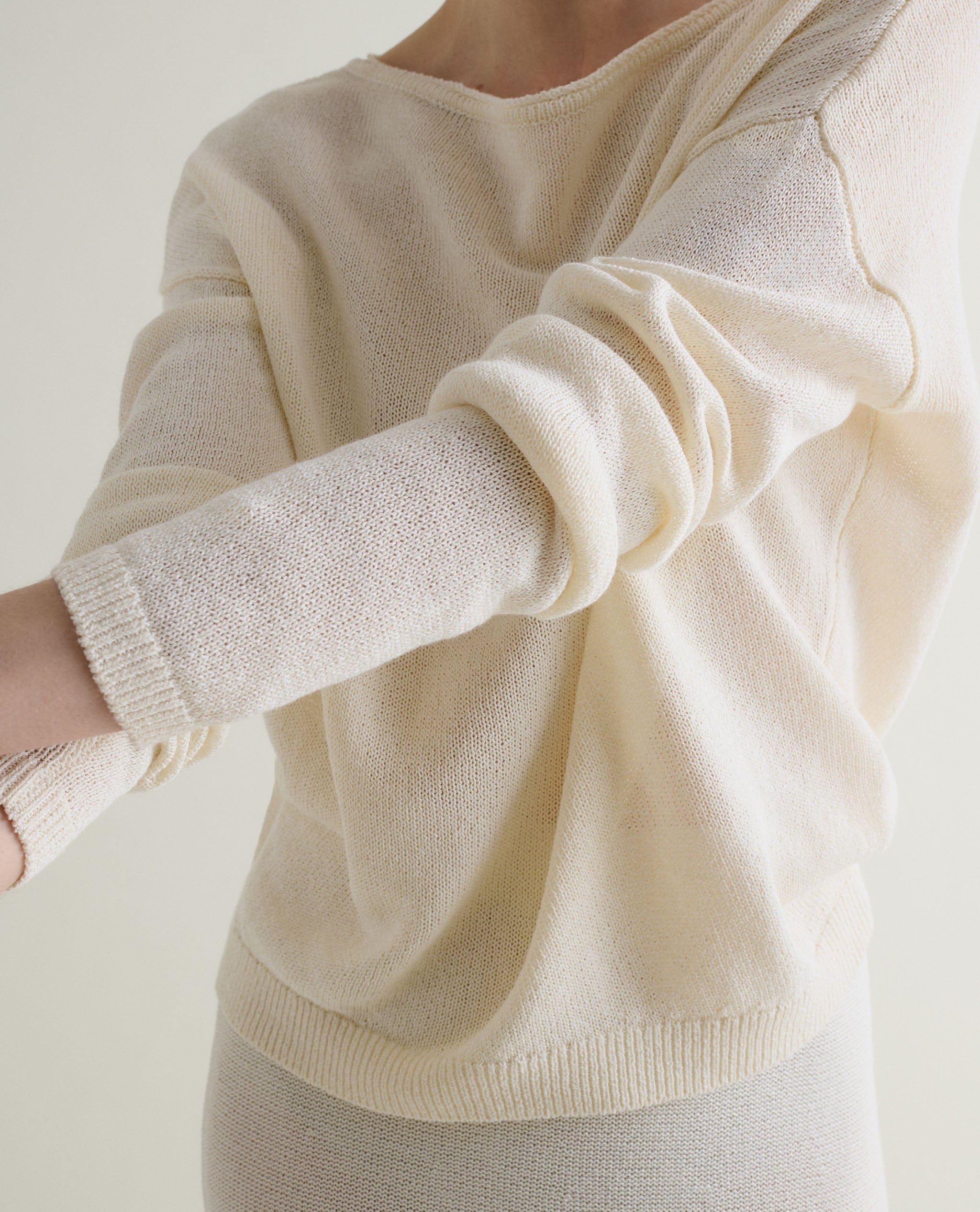 Woman wears cream cotton bouclé knit t-shirt
