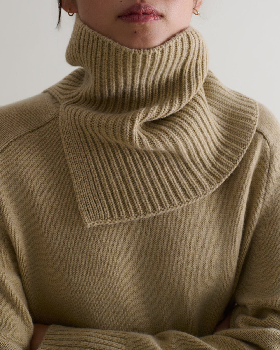 Close-up of a woman wearing twine cashmere merino ribbed collar over a matching jumper