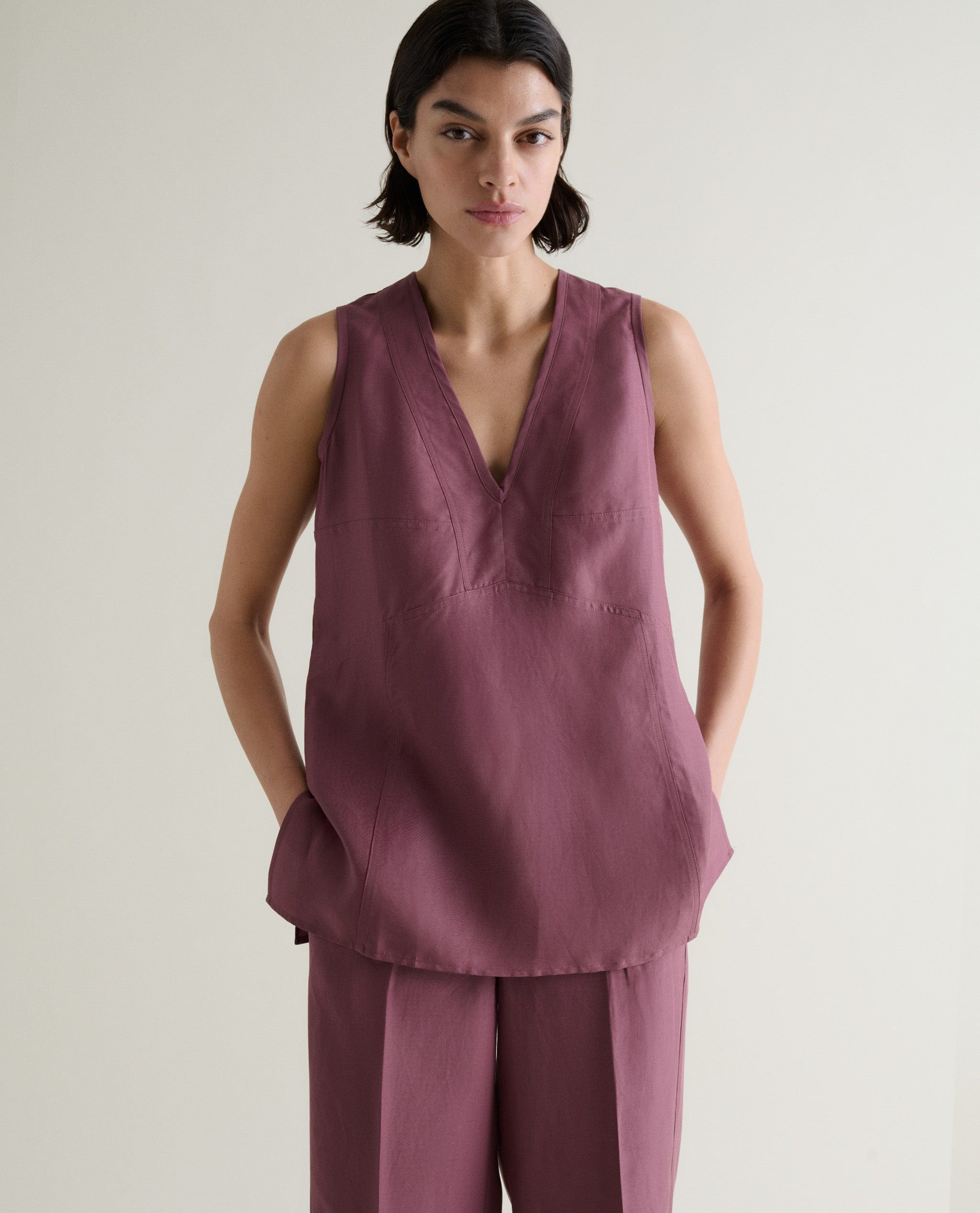 Fitted at bust, gently flaring at hem.