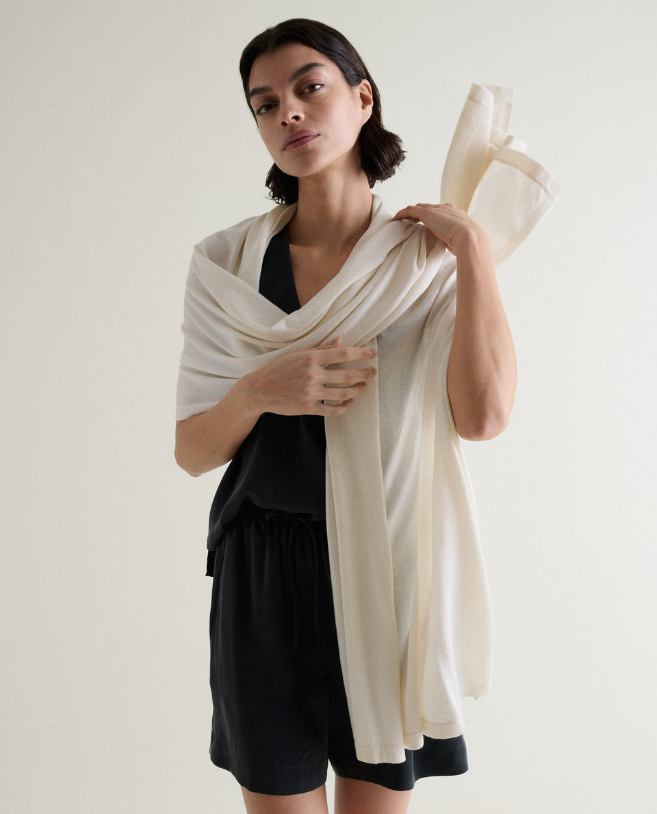 Woman Draping A Cream Silk-Cashmere Scarf Over Her Shoulders