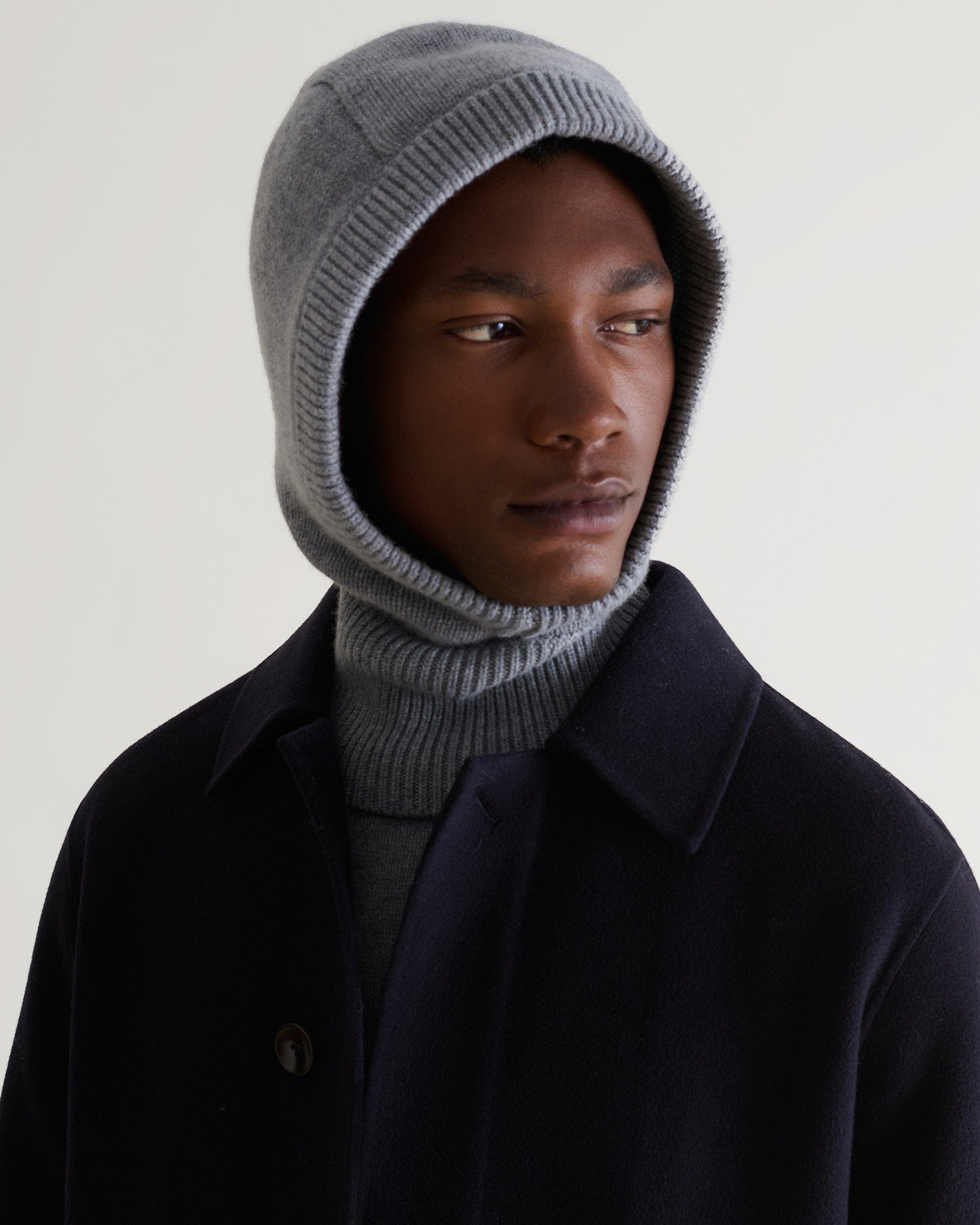 Image 1 of 2 showing man wearing Rise & Fall's grey Cashmere Merino Knitted Hood.