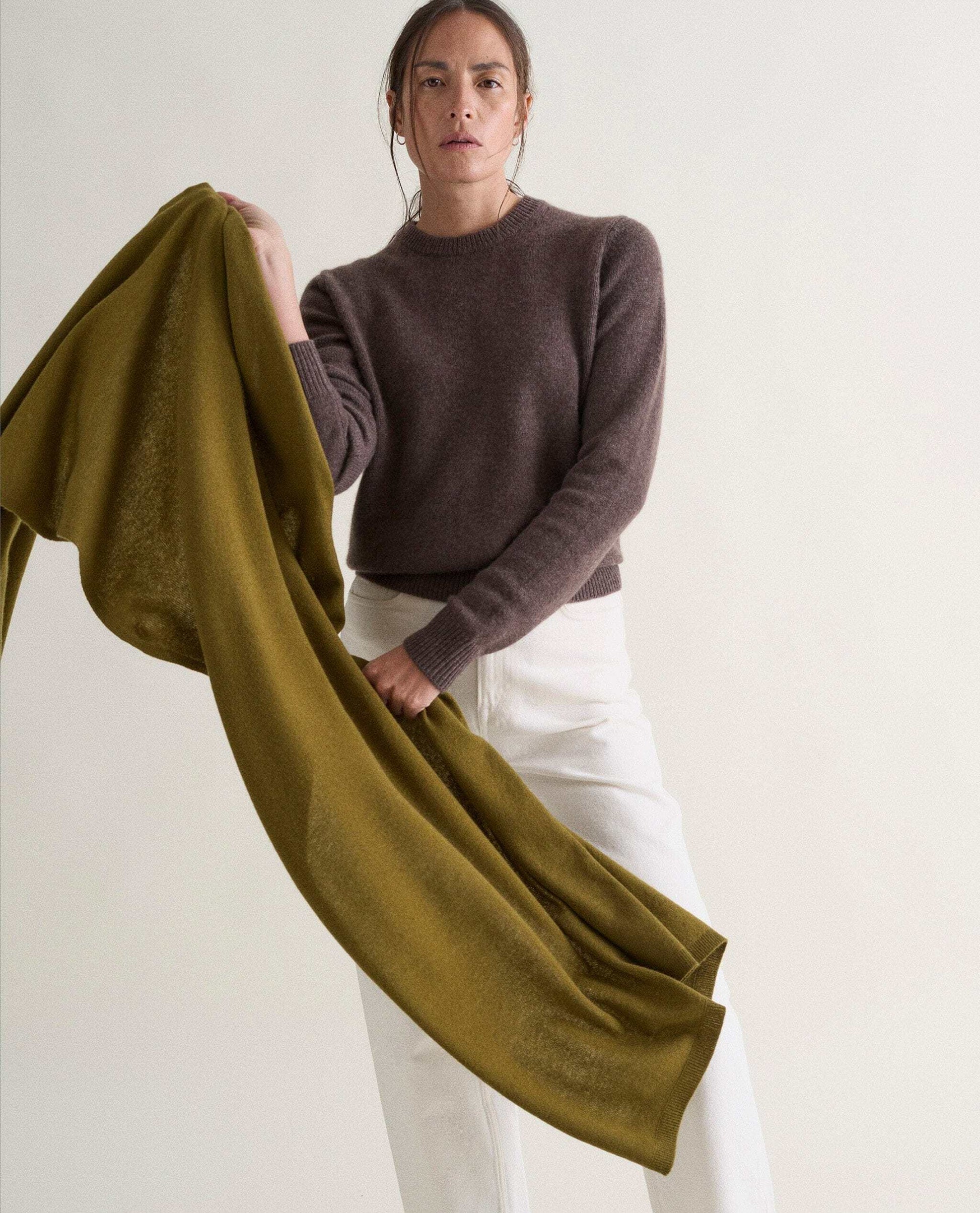 Image 1 of 2 showing woman throwing oversized cashmere scarf around shoulders, colour: olive