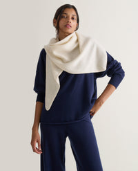 Image 1 of 2 showing woman wearing Rise & Fall's cream Cashmere Merino Bandana.