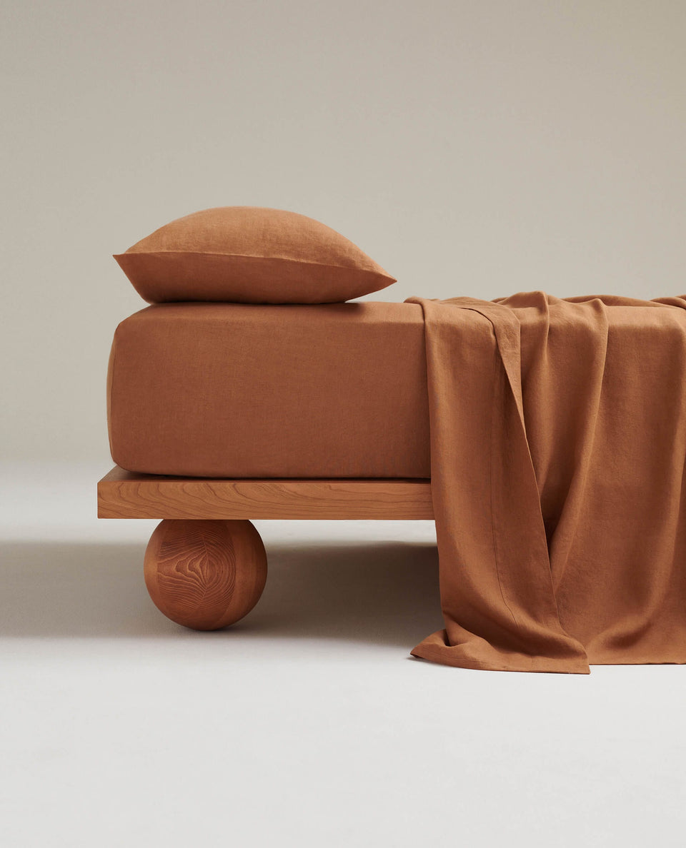 Image 1 of 3 showing Rise & Fall's Relaxed & Refined linen flat bed sheet in ochre.