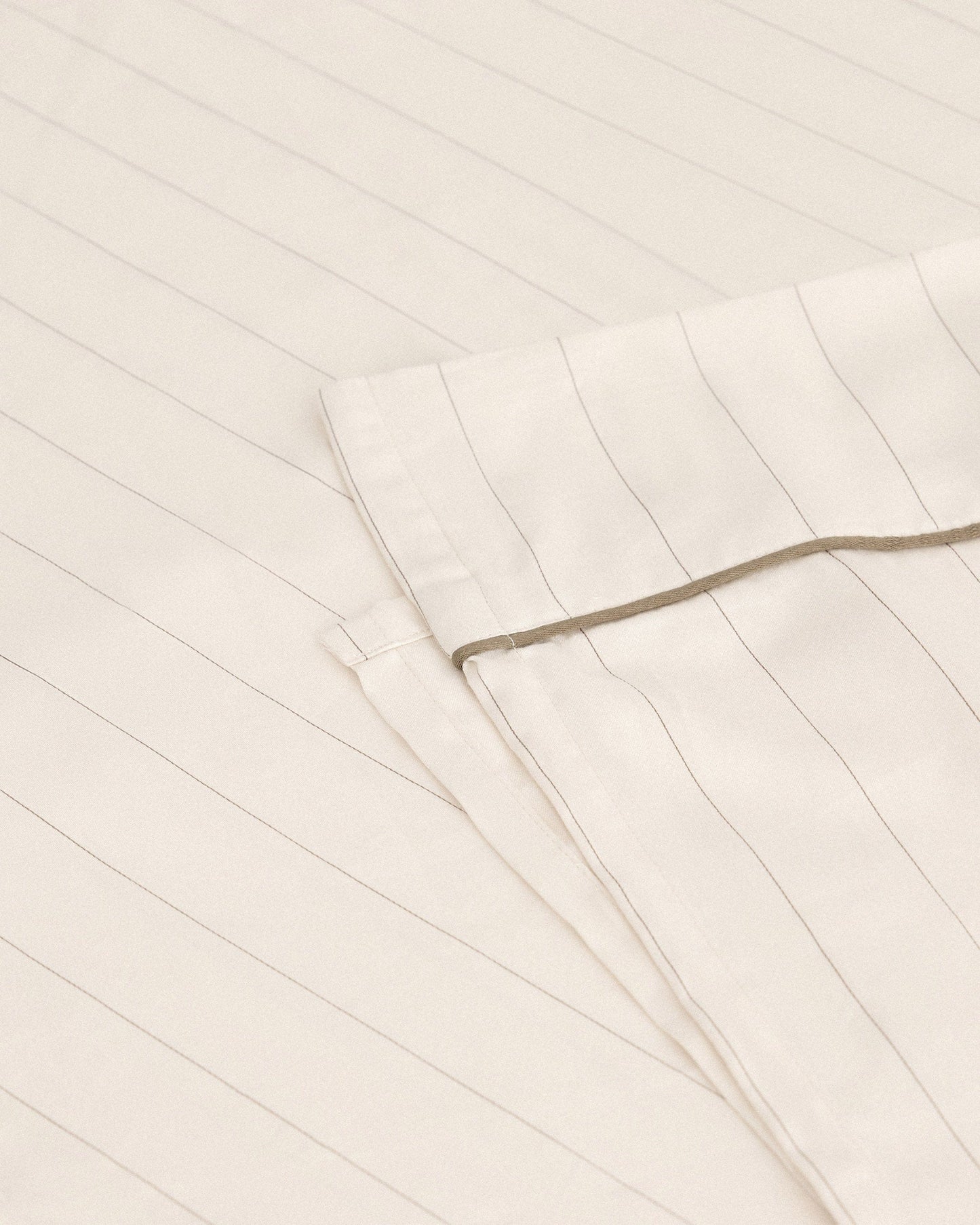 Image 1 of 3 showing Rise & Fall's Soft & Smooth organic sateen cotton flat sheet in buttermilk stripe.
