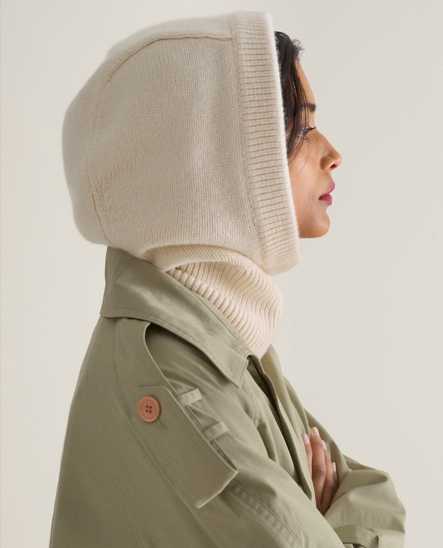 Image 1 of 3 showing woman wearing Rise & Fall's cream Cashmere Merino Knitted Hood.