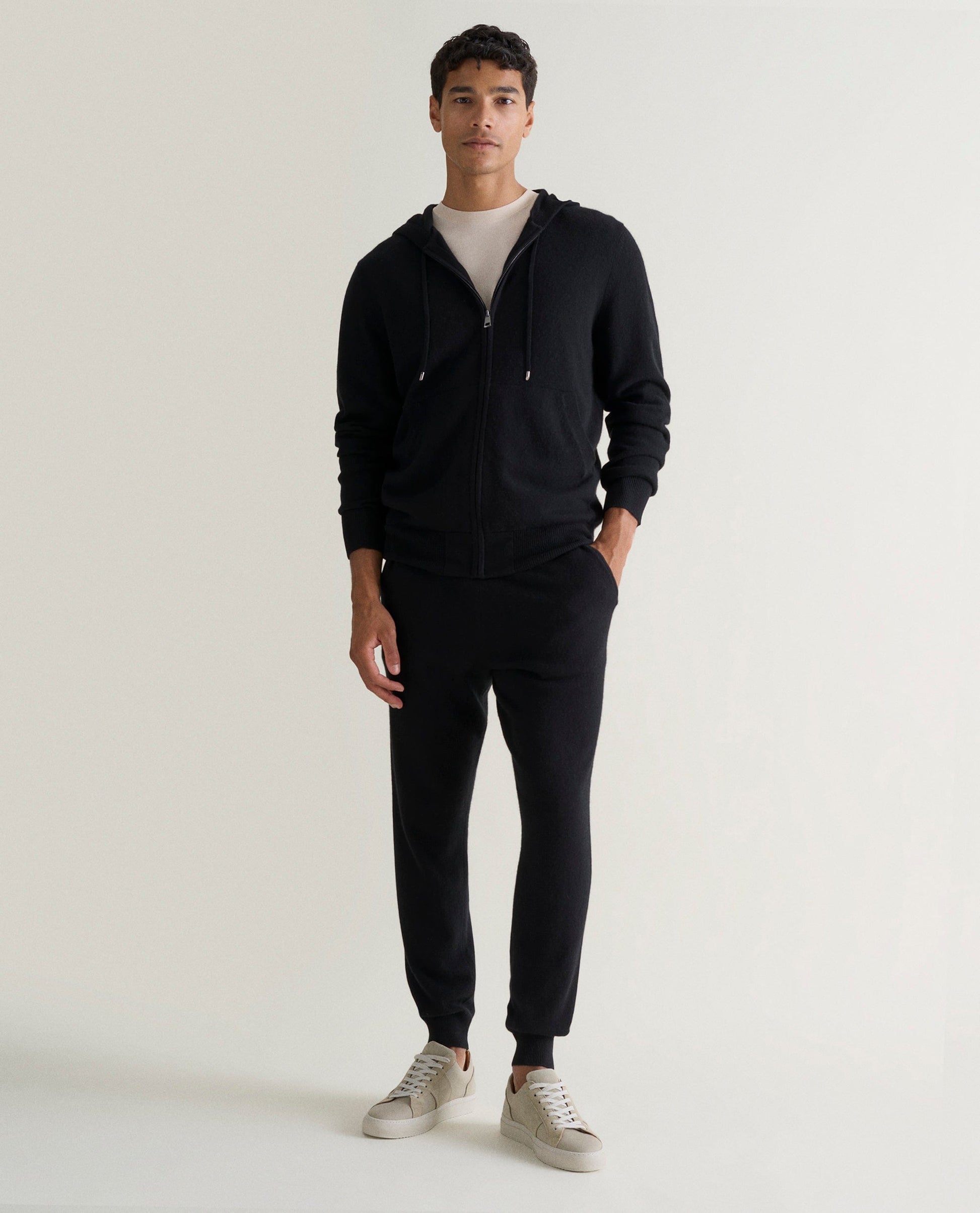 Image 1 of 4 showing man wearing Rise & Fall's fine cashmere zip hoodie, black.