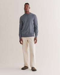 Image 1 of 4 showing man wearing Rise & Fall's merino mid-weight crew neck jumper in grey.