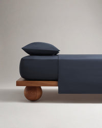 Image 1 of 4 showing Rise & Fall's Soft & Smooth organic sateen cotton flat sheet in mood indigo. 