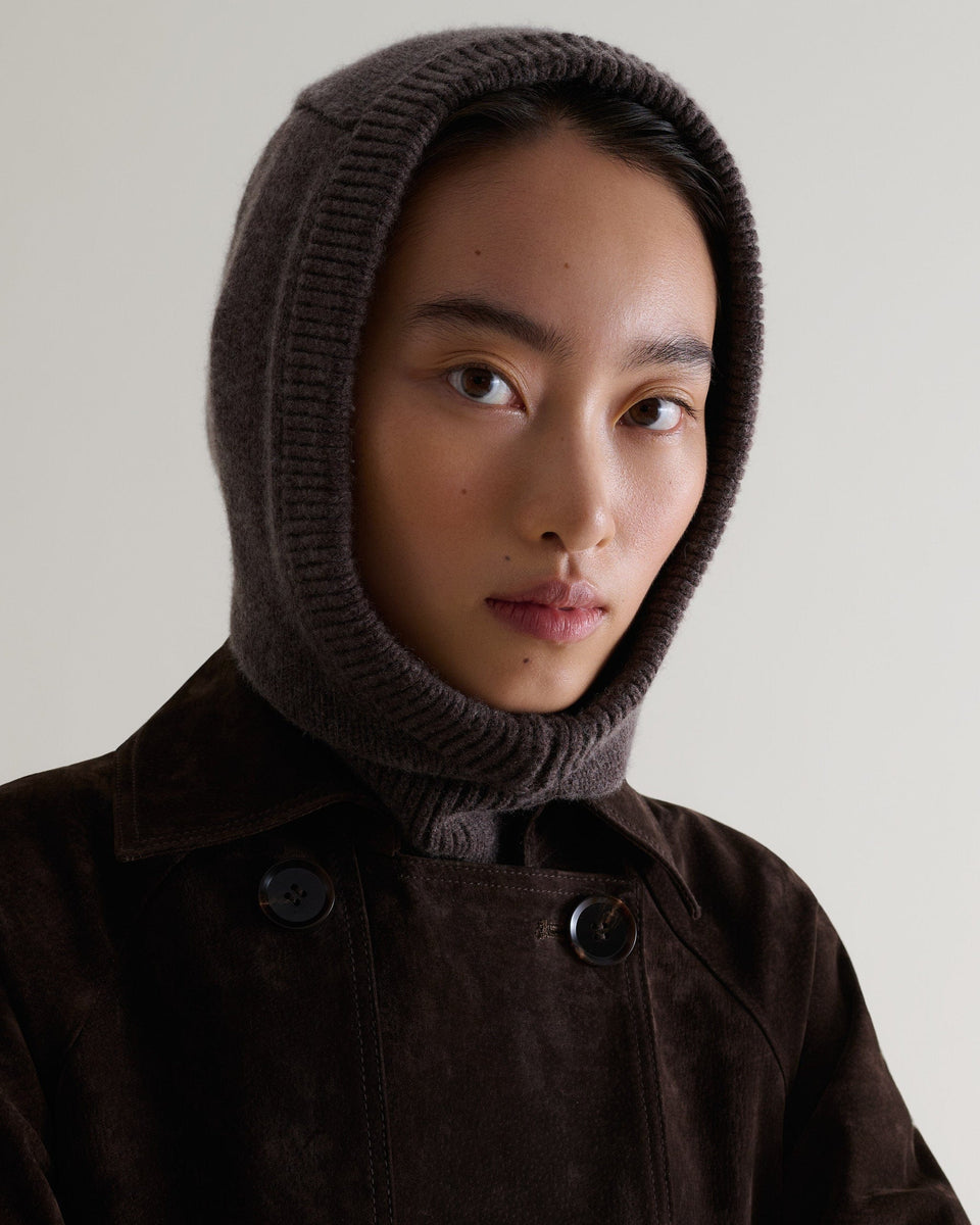 Image 1 of 4 showing woman wearing Rise & Fall's chocolate brown Cashmere Merino Knitted Hood.