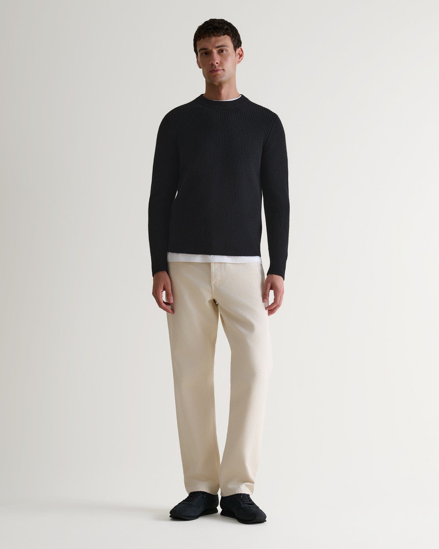 Image 1 of 5 showing man wearing Rise & Fall's Cashmere Merino Fishermans Rib Crew Neck Jumper in black.