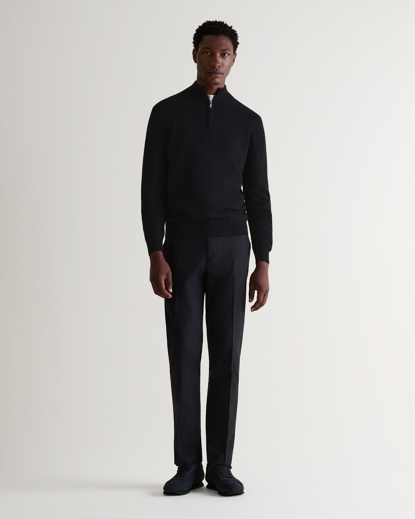 Image 1 of 5 showing man wearing Rise & Fall's fine cashmere 1/4 zip jumper, black