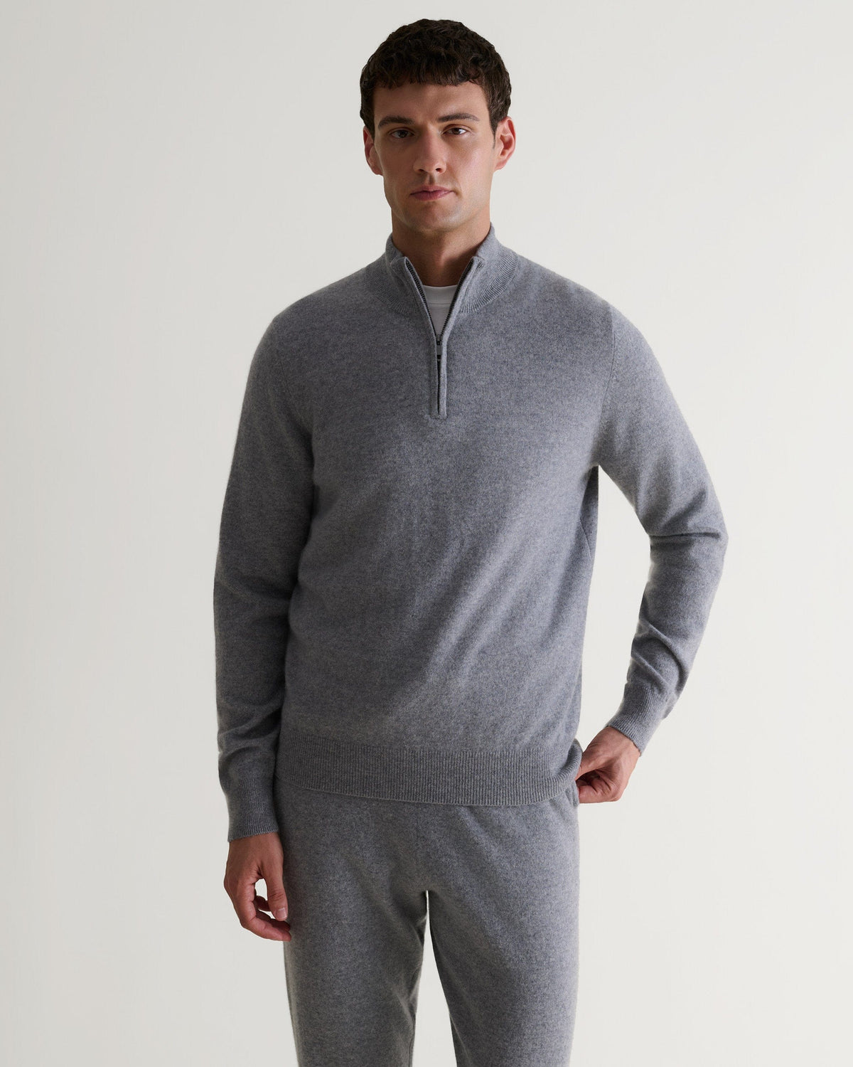 Image 1 of 5 showing man wearing Rise & Fall's fine cashmere 1/4 zip jumper, grey.