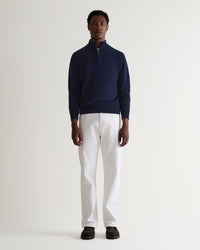 Image 1 of 5 showing man wearing Rise & Fall's fine cashmere 1/4 zip jumper, navy.