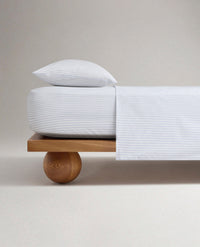 Image 1 of 5 showing Rise & Fall's Crisp & Cool organic percale cotton flat bed sheet in blue ticking stripe.