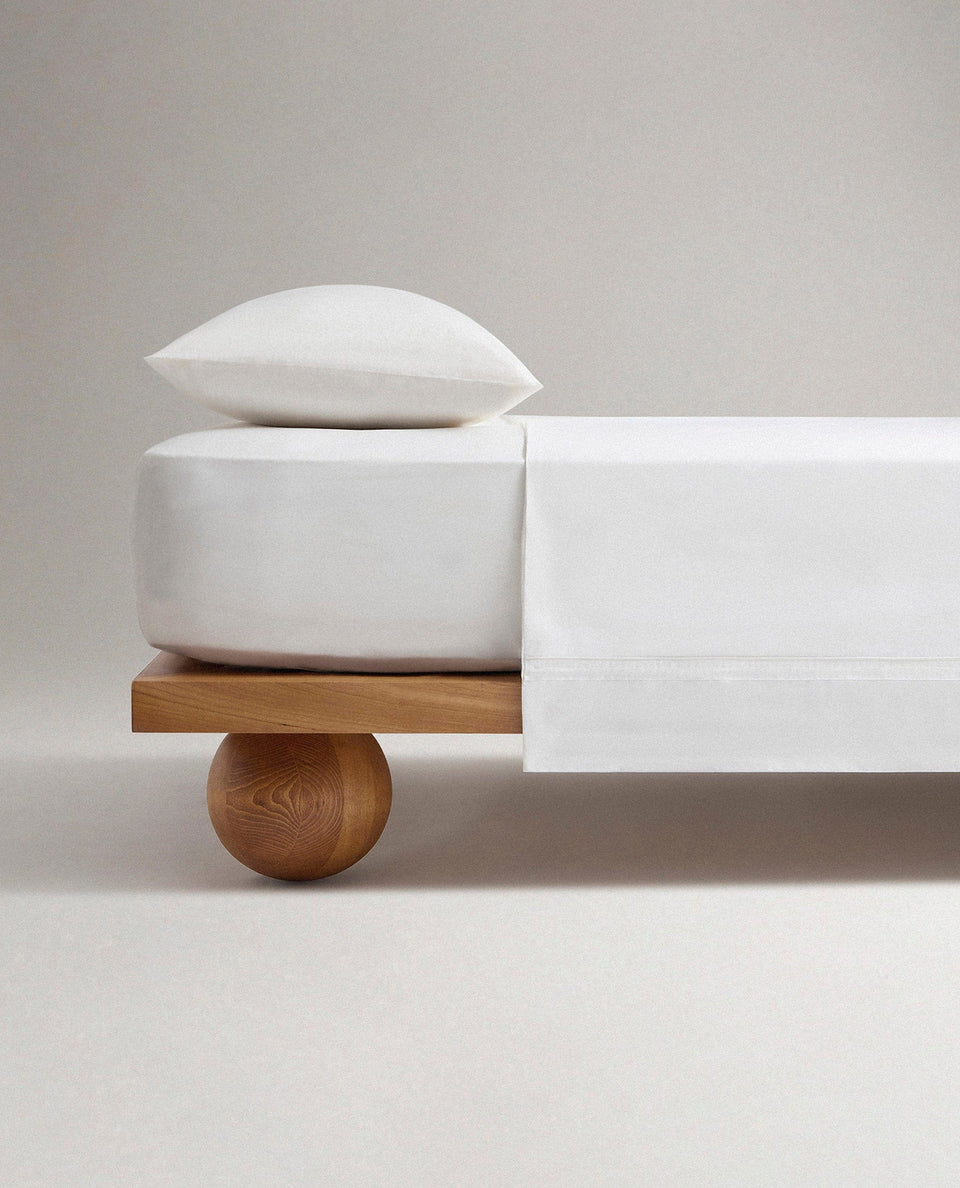 Image 1 of 5 showing Rise & Fall's Crisp & Cool organic percale cotton flat bed sheet in white tailored border.