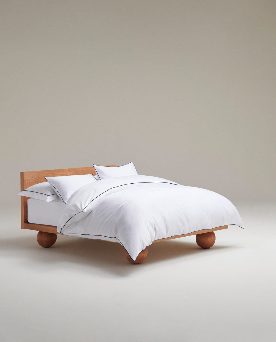 Image 1 of 5 showing Rise & Fall's percale cotton duvet cover, colour: white navy piping.