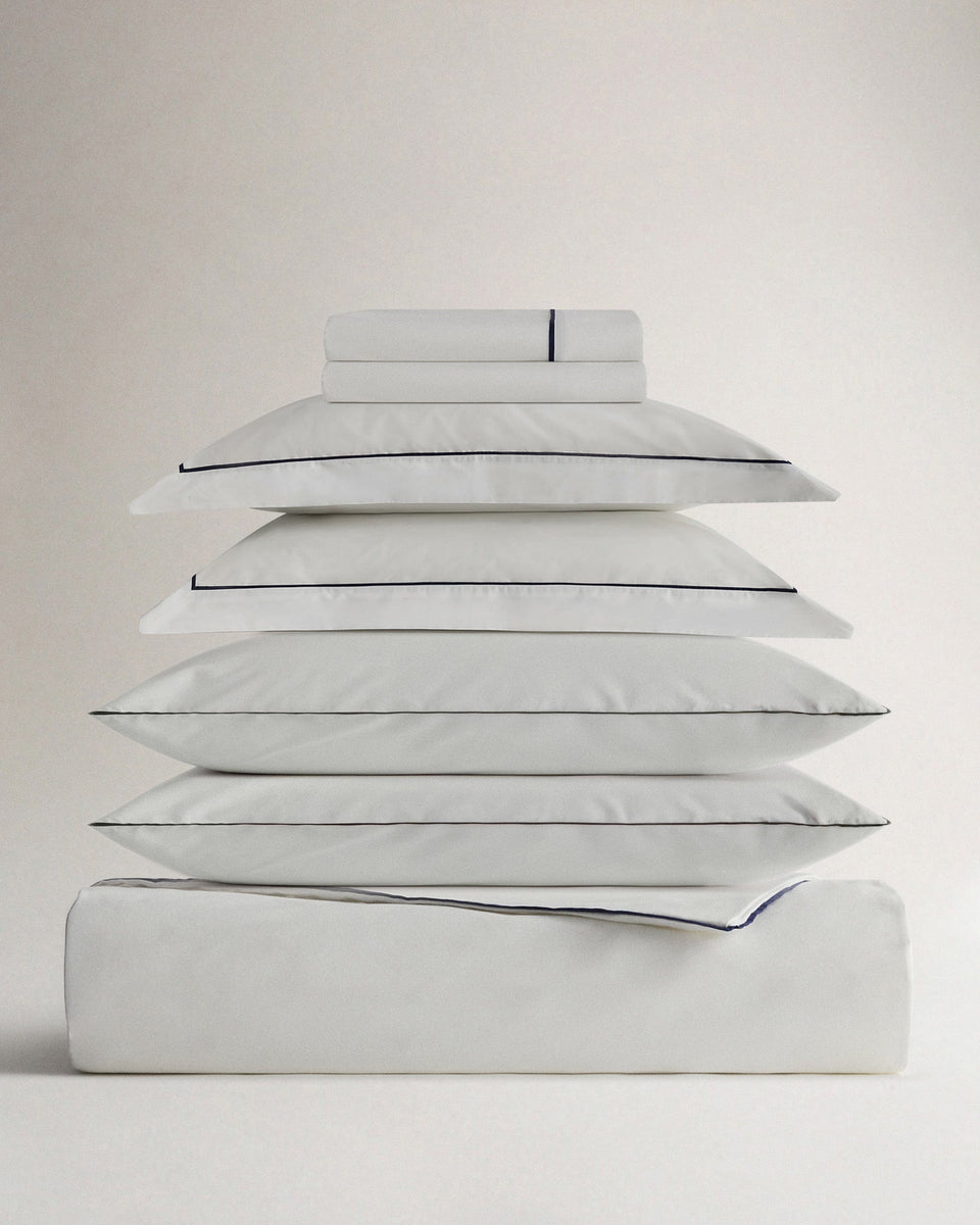 Image 1 of 5 showing Rise & Fall's Soft & Smooth organic sateen cotton comforter set, colour: white navy piping, size: king.