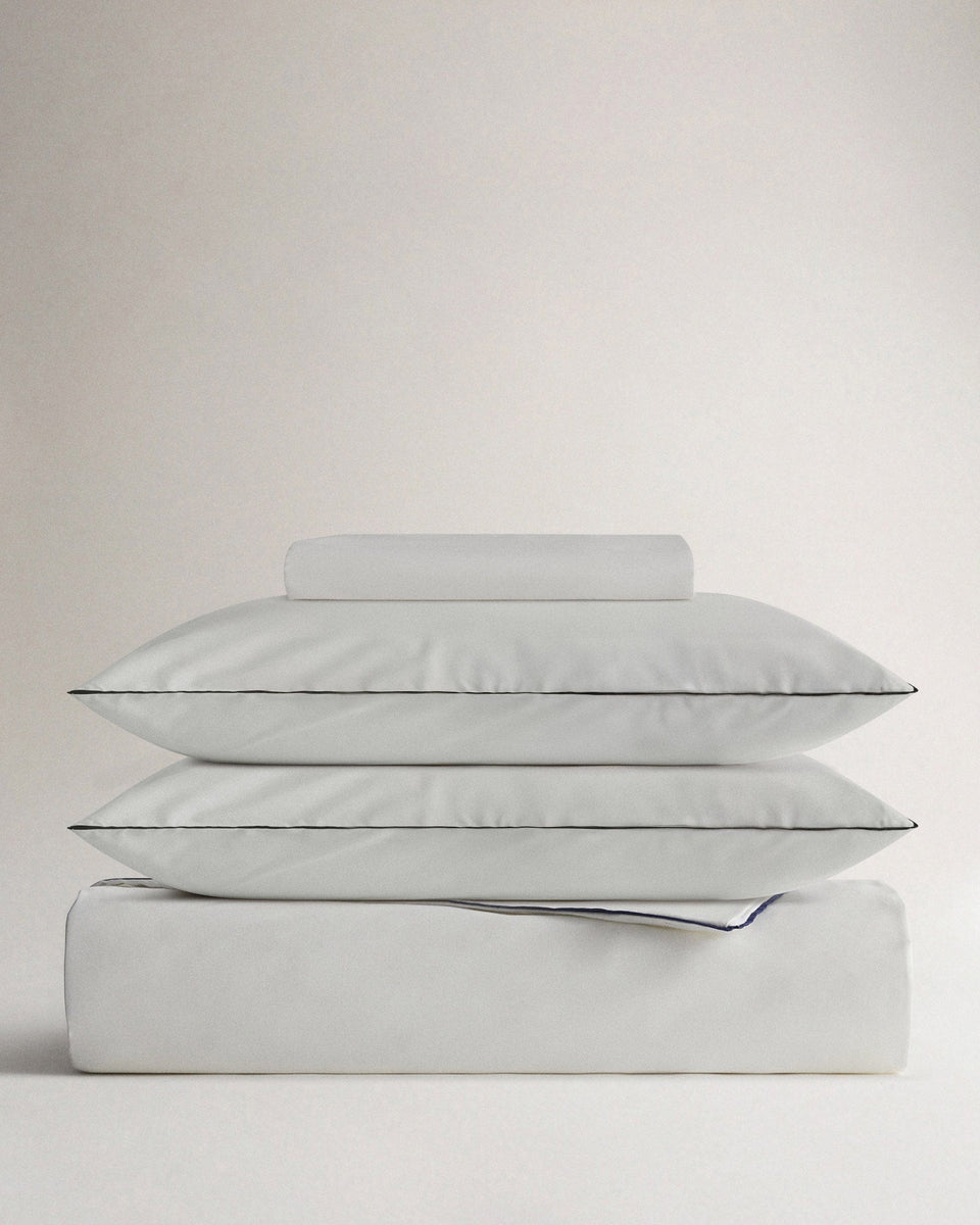image 1 of 5 showing bed with Rise & Fall's Crisp & Cool duvet set, colour: white navy pipiing, fabric: percale cotton