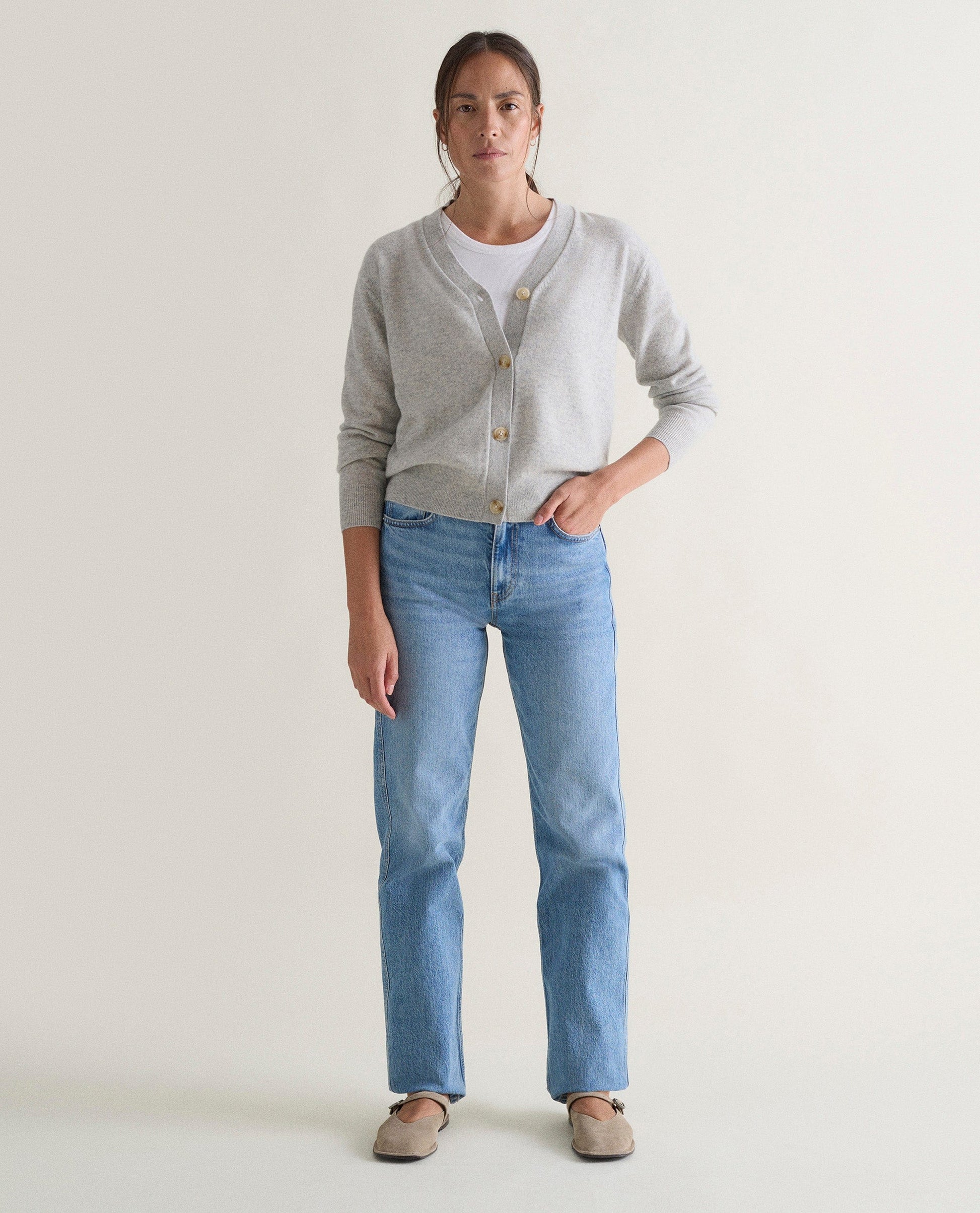 Image 1 of 5 showing woman wearing Rise & Fall's grey fine cashmere v-neck cardigan.