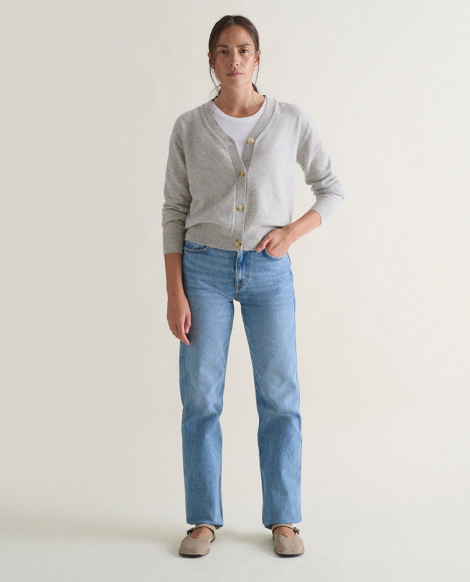 Image 1 of 5 showing woman wearing Rise & Fall's grey fine cashmere v-neck cardigan.