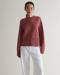 Image 1 of 5 showing woman wearing Rise & Fall cashmere merino saddle sleeve crew neck jumper, colour: pink clay.