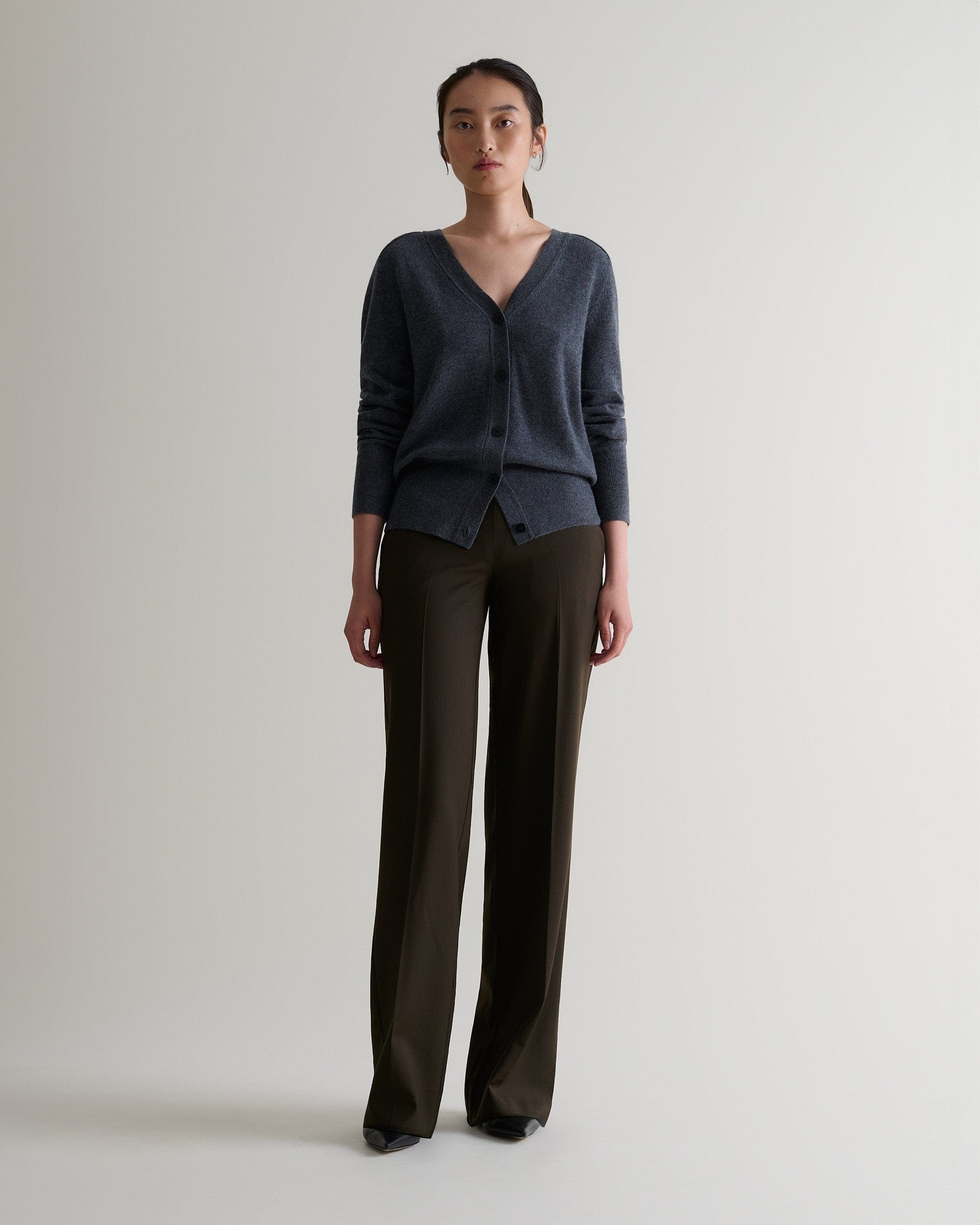 Image 1 of 5 showing woman wearing Rise & Fall's fine cashmere blouson cardigan, colour: graphite.
